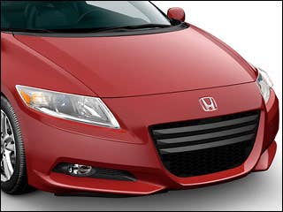 The CR-Z’s greatest asset is its design, as the short, squat, and aggressively styled little coupe looks like it’s going fast even while parked. Multiple character lines sweep back from a wide front grille opening, up and back to the high rear hatchback. The hatch features a tinted vertical glass panel for rearward visibility, while the larger window is nearly parallel to the ground, almost as an extension of the roof. If there is a fault to the exterior design, it would be in the standard 16-inch wheels, which appear too small, especially in the back.Research the 2011 Honda CR-Z2011 Honda CR-Z Photos2011 Honda CR-Z Available Trims2011 Honda CR-Z Pricing & Quotes