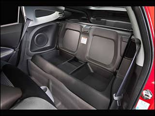 For as slick as the CR-Z’s interior is, what’s most notable is what’s missing: The back seat. In other markets, this two-seater will be sold as a “2+2,” but in North America we get two odd storage cubbies and a fold-down “cargo cover” (the vestigial seatback) instead of the kid-size seating. While Honda’s product planners probably see this as part of the car’s sportiness, it seems more likely to relegate the CR-Z to performing the same sort of commuter car duty as most first generation Insight two-seaters. Research the 2011 Honda CR-Z2011 Honda CR-Z Photos2011 Honda CR-Z Available Trims2011 Honda CR-Z Pricing & Quotes