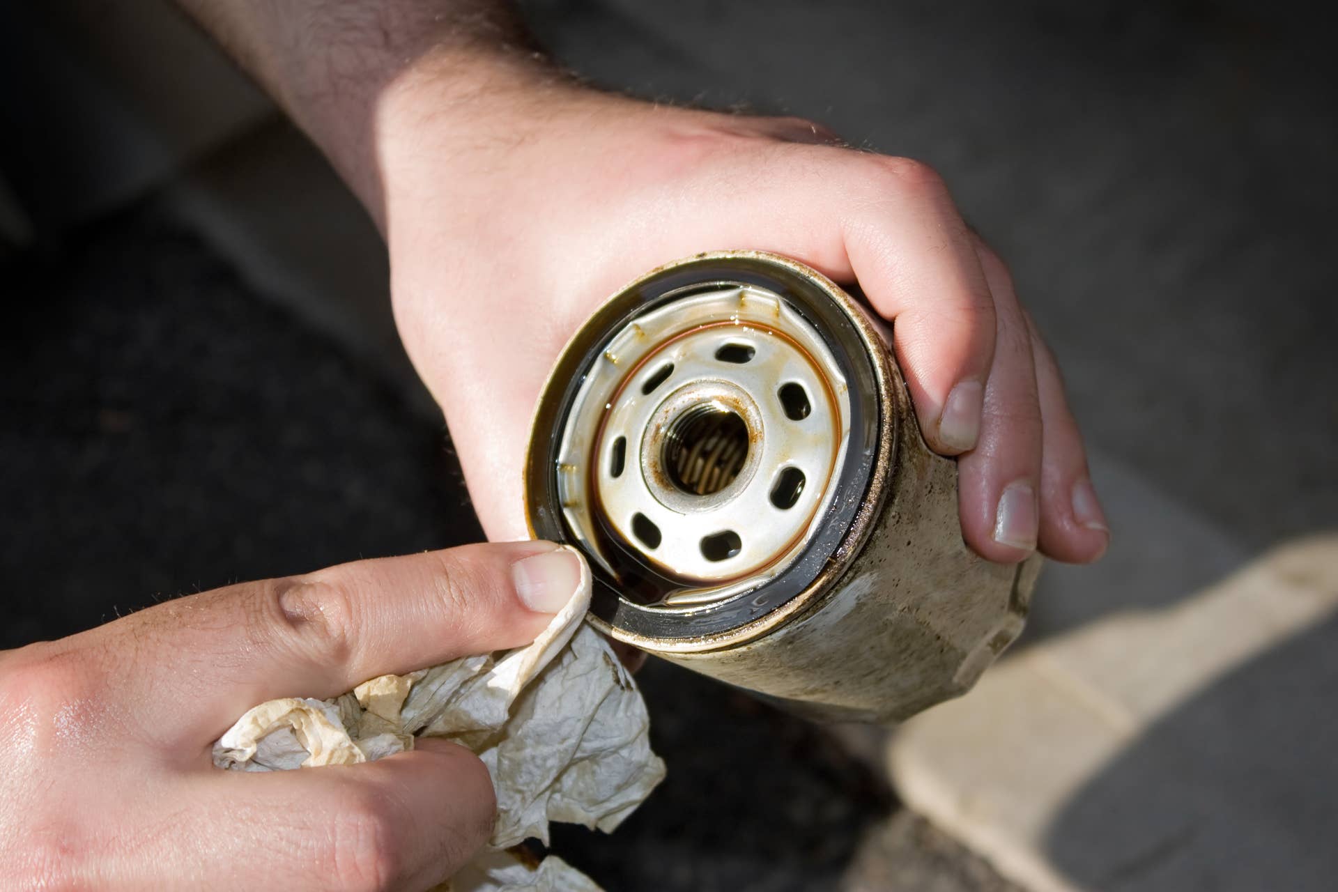 a backyard mechanic wipes the...