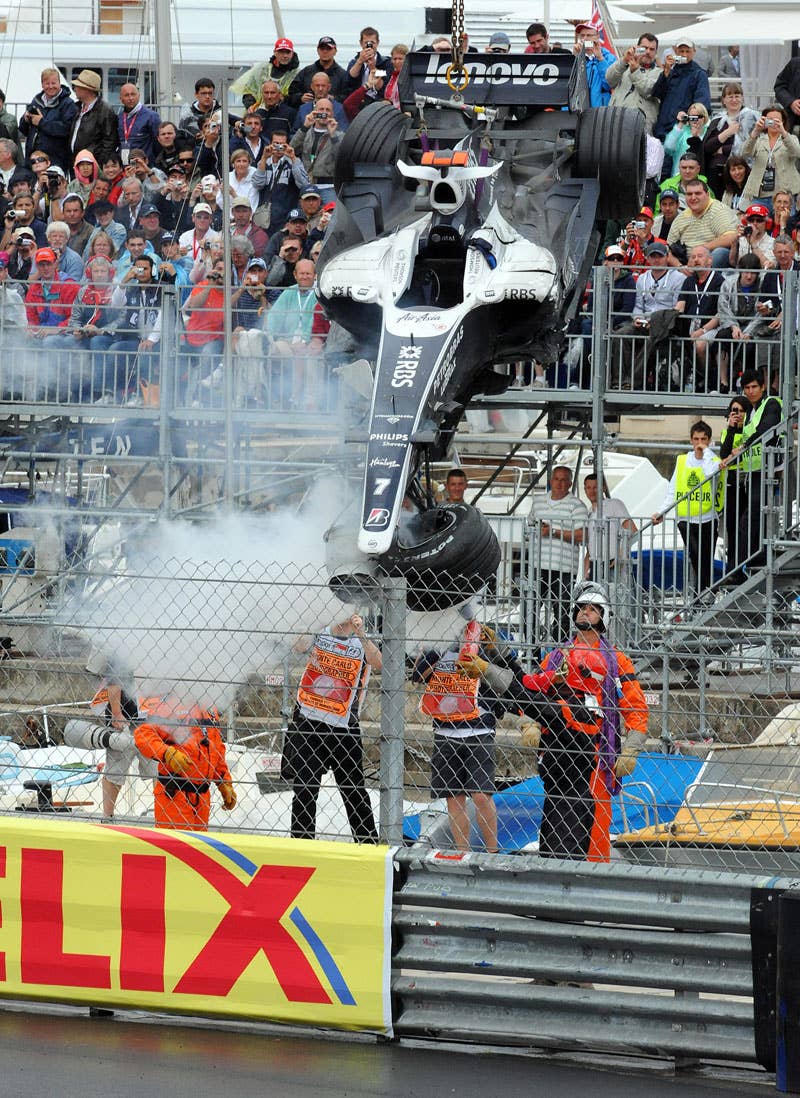 A crane lifts the car of Williams' German driver Nico Rosberg at the Monaco racetrack on May 25, 2008 in Monte Carlo, during the Monaco Formula One Grand Prix. McLaren Mercedes' British driver Lewis Hamilton won the race ahead of BMW Sauber's Polish driver Robert Kubica and Ferrari Brazilian's driver Felipe Massa. AFP PHOTO / POOL / PASCAL GUYOT (Photo credit should read PASCAL GUYOT/AFP/Getty Images)