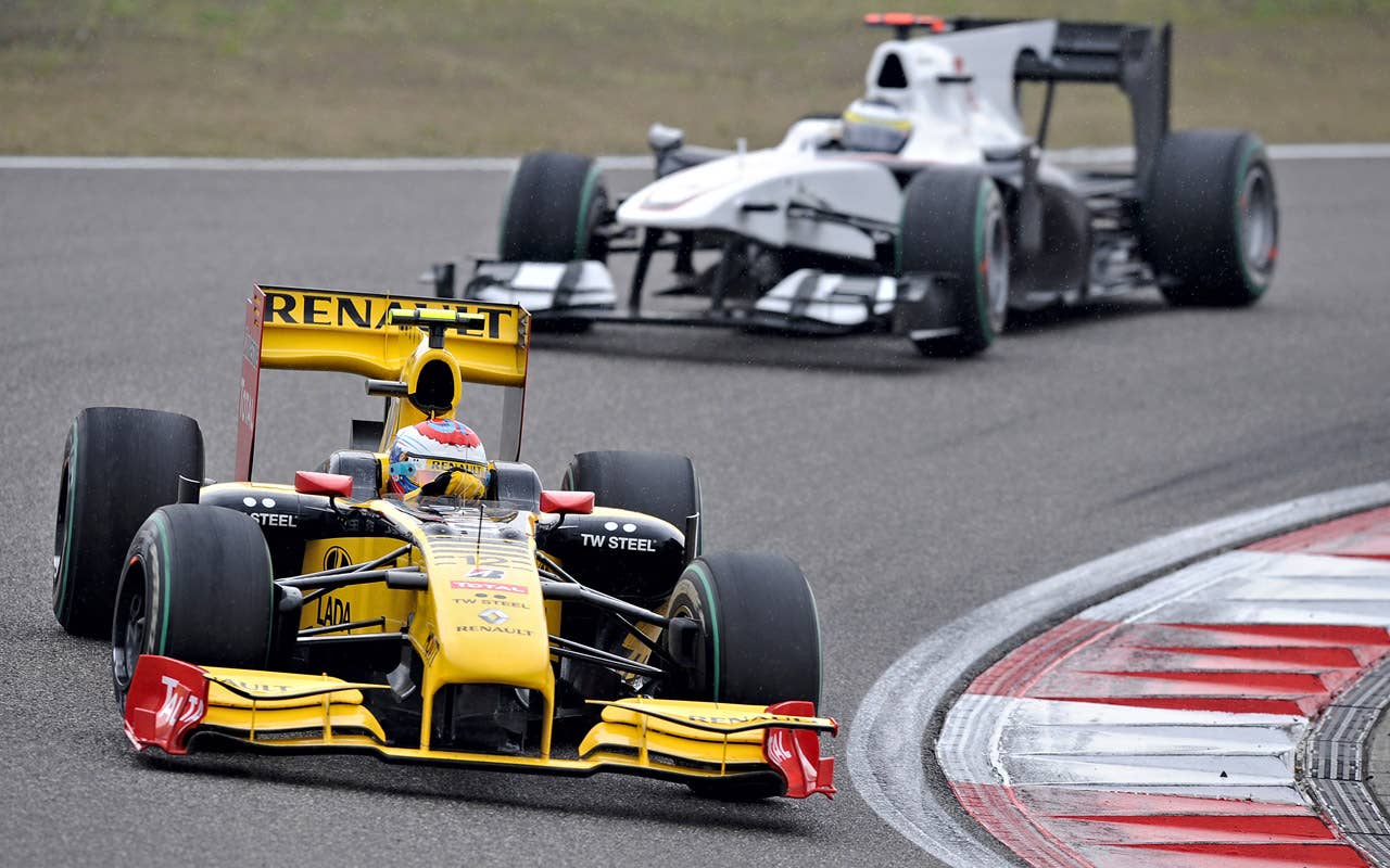 Renault driver Vitaly Petrov of Russia (L) powers his car during Formula One's Chinese Grand Prix in Shanghai on April 18, 2010. Petrov finished the race in seventh place.   AFP PHOTO / PHILIPPE LOPEZ (Photo credit should read PHILIPPE LOPEZ/AFP/Getty Images)