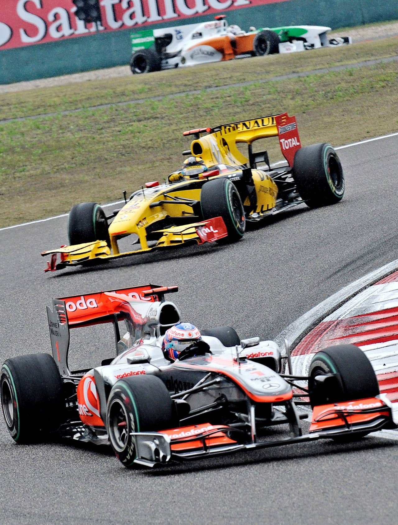 McLaren-Mercedes driver Jenson Button of Britain (bottom) powers his car during Formula One's Chinese Grand Prix in Shanghai on April 18, 2010. Button won in a time of 1h46:42.163.    AFP PHOTO / PHILIPPE LOPEZ (Photo credit should read PHILIPPE LOPEZ/AFP/Getty Images)