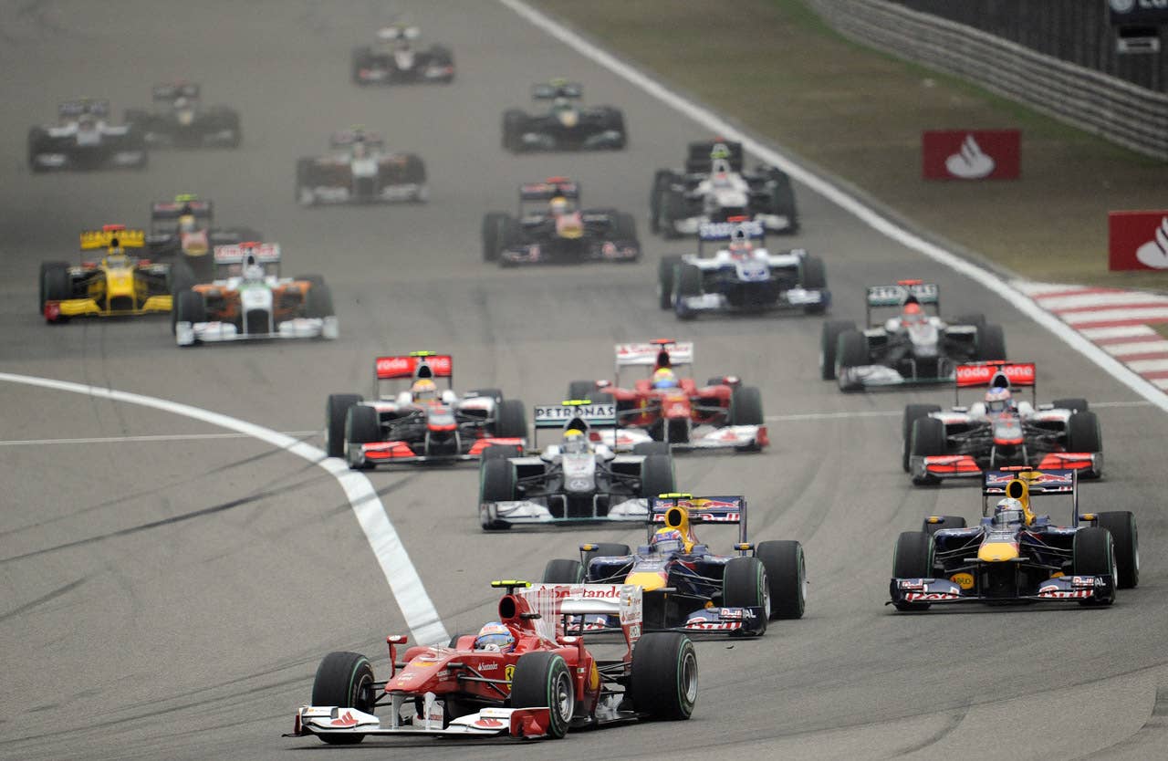 Ferrari's Fernando Alonso of Spain (C-bottom) jumps the start to lead Formula One's Chinese Grand Prix in Shanghai on April 18, 2010. Alonso went on to finish the race in fourth place.   AFP PHOTO/Peter PARKS (Photo credit should read PETER PARKS/AFP/Getty Images)