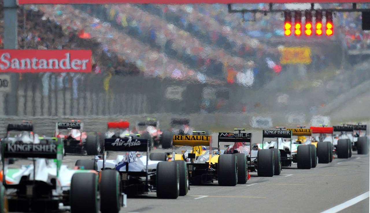 The cars start from the grid during Formula One's Chinese Grand Prix in Shanghai on April 18, 2010.  Defending champion Jenson Button delivered a perfectly judged drive in treacherous wet conditions to win the dramatic Chinese Grand Prix ahead of his McLaren teammate Lewis Hamilton.  AFP PHOTO/GOH CHAI HIN (Photo credit should read GOH CHAI HIN/AFP/Getty Images)