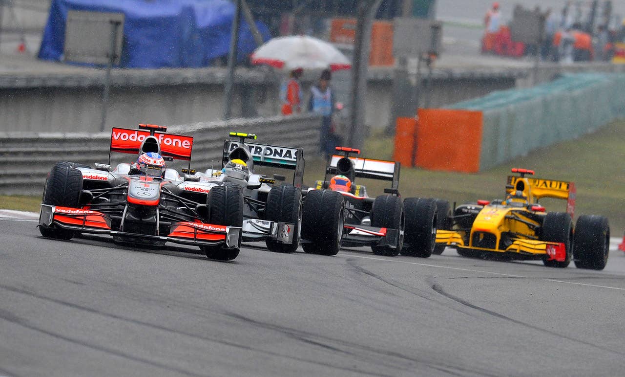 McLaren-Mercedes driver Jenson Button (L) of Britain drives his car to victory in Formula One's Chinese Grand Prix in Shanghai on April 18, 2010.  Button won in a time of 1h46:42.163.   AFP PHOTO / GOH CHAI HIN (Photo credit should read GOH CHAI HIN/AFP/Getty Images)