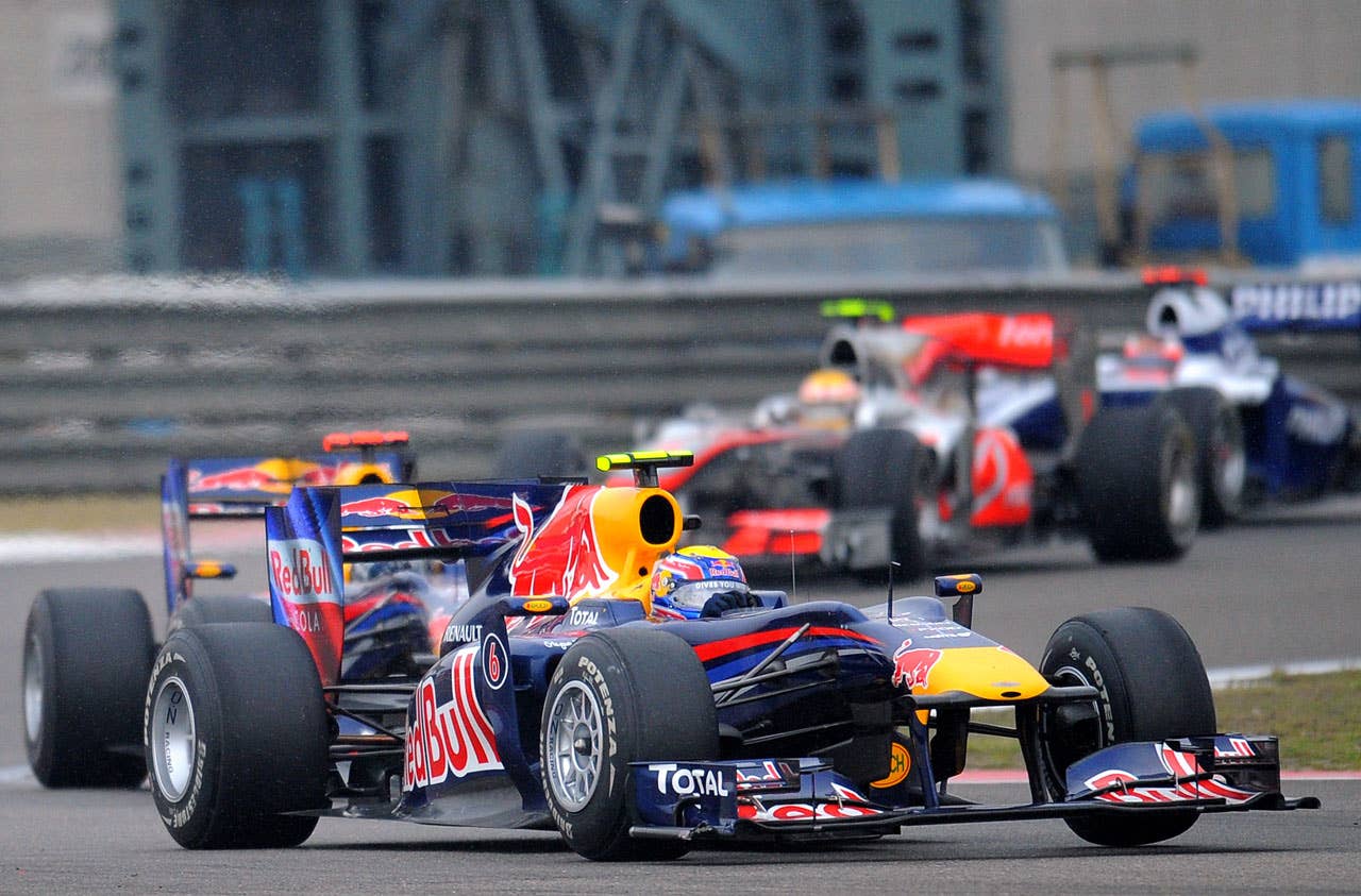 Red Bull-Renault driver Mark Webber of Australia (C) drives his car during Formula One's Chinese Grand Prix in Shanghai on April 18, 2010. Webber finished the race in eighth place.   AFP PHOTO/GOH CHAI HIN (Photo credit should read GOH CHAI HIN/AFP/Getty Images)
