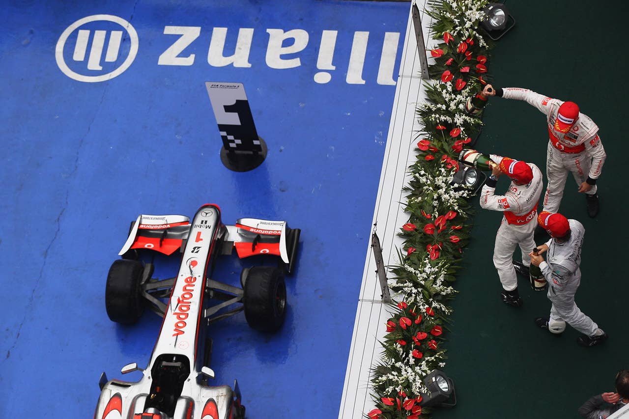 SHANGHAI, CHINA - APRIL 18:  Race winner Jenson Button (centre) of Great Britain and McLaren Mercedes is congratulated on the podium by second placed team mate Lewis Hamilton (top) of Great Britain and McLaren Mercedes and third placed Nico Rosberg (bottom) of Germany and Mercedes GP after the Chinese Formula One Grand Prix at the Shanghai International Circuit on April 18, 2010 in Shanghai, China.  (Photo by Mark Thompson/Getty Images) *** Local Caption *** Jenson Button;Lewis Hamilton;Nico Rosberg