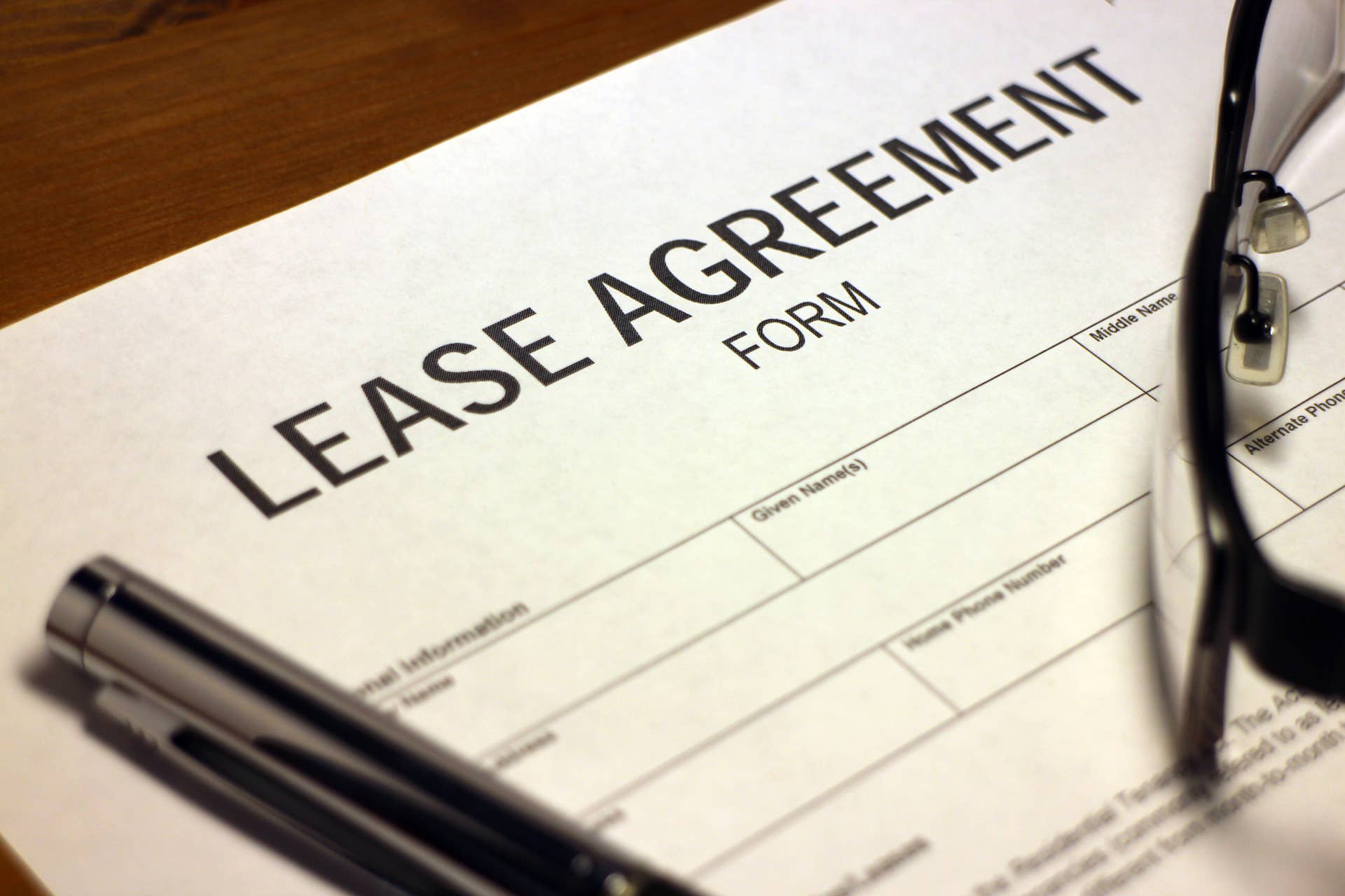 Someone filling out Lease Agreement Form.