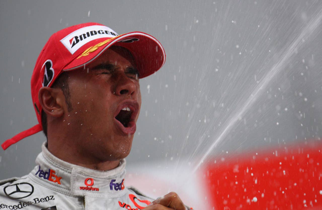 SHANGHAI, CHINA - OCTOBER 19: Lewis Hamilton of Great Britain and McLaren Mercedes celebrates on the podium after winning the Chinese Formula One Grand Prix at the Shanghai International Circuit on October 19, 2008 in Shanghai, China. (Photo by Vladimir Rys/Getty Images)