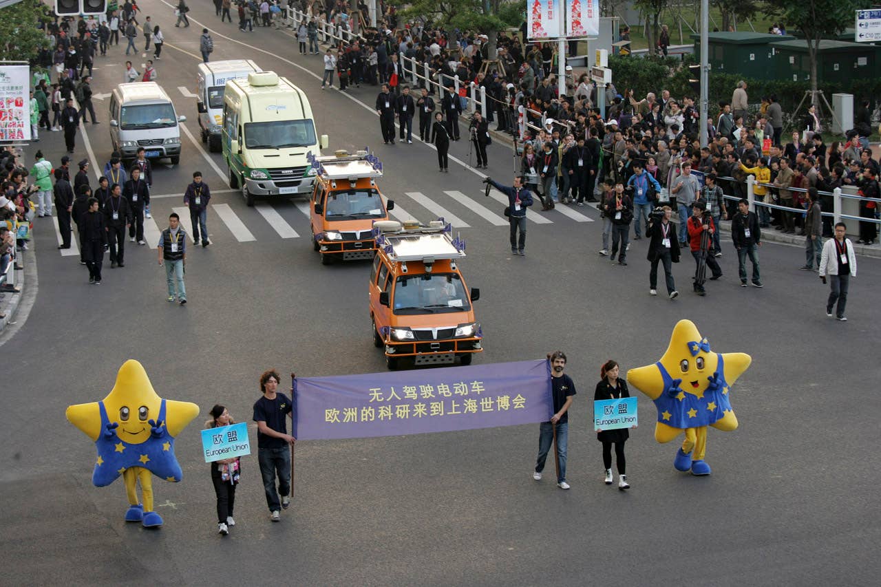 Two driverless vehicles, in orange, equipped with laser scanners and cameras that work in concert to detect and help avoid obstacles, travel on the Shanghai Expo site to attend the official celebration of their arrival Thursday Oct. 28, 2010 in Shanghai, China. A team of Italian engineers launched what has been billed as the longest-ever test drive of driverless vehicles: a 13,000-kilometer (8,000-mile), three-month road trip from Italy to China. (AP Photo)