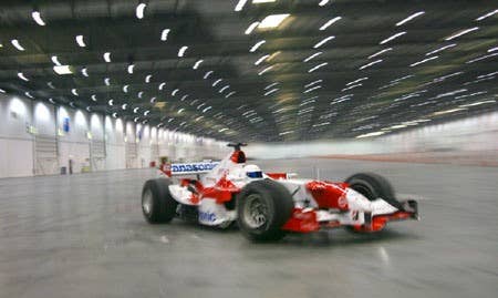 The Stig drives Toyota F1 car indoors
