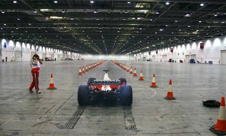 The Stig drives Toyota F1 car indoors