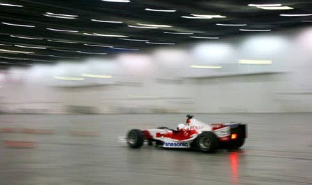 The Stig drives Toyota F1 car indoors