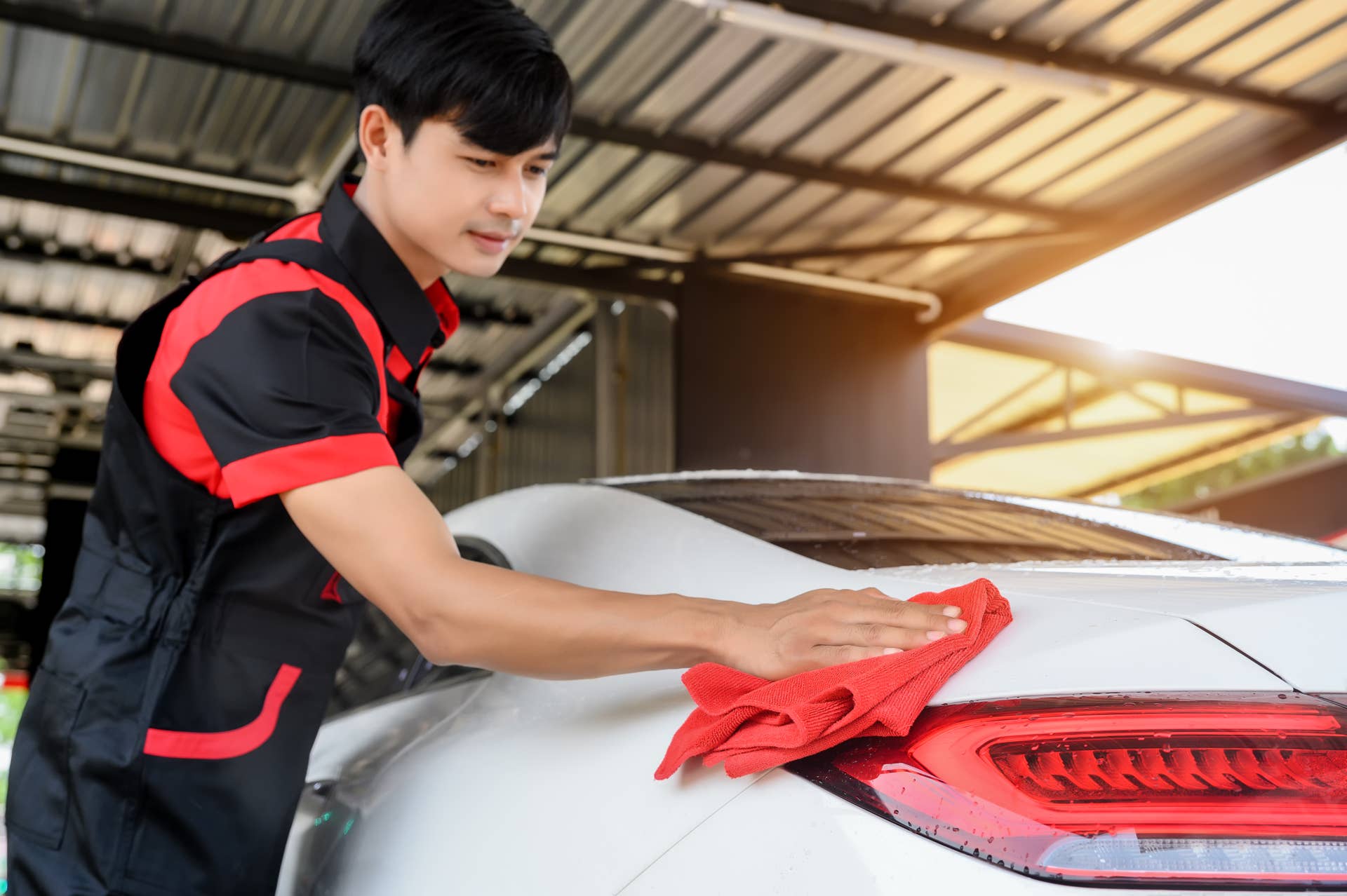 Car Wash Services, Cleaning with Cloth at Car Wash and Detailing Station for Vehicle's Maintenance. Expert Car Cleaning and Grooming at Car Wash Station.
