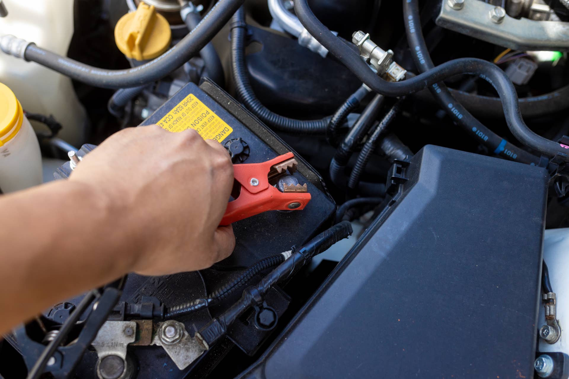 Connecting jumper cables to a lead-acid car battery
