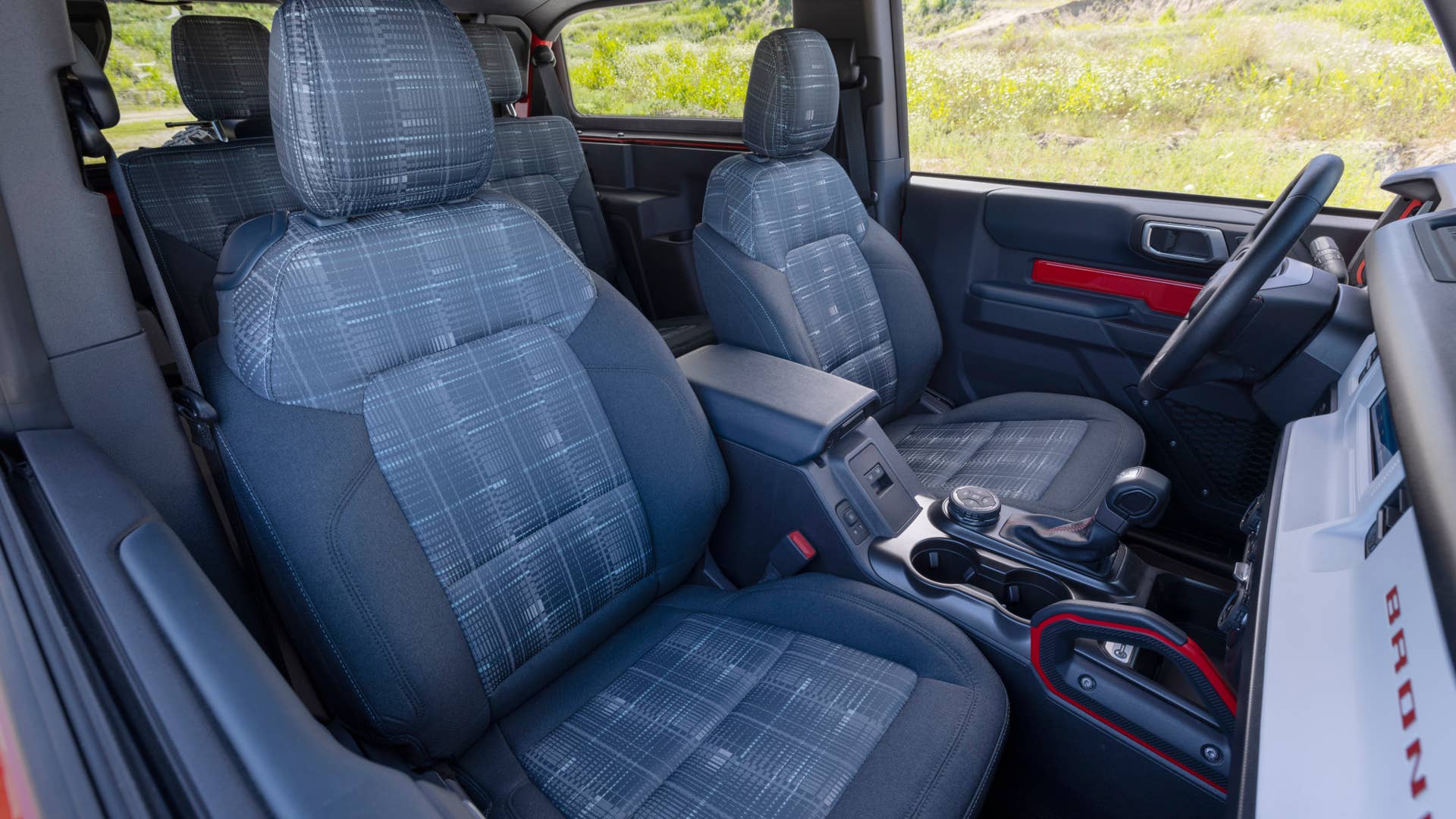 Bronco Heritage Edition available winter 2023. Limited availability. Preproduction models shown.  Always consult the Owner’s Manual before off-road driving, know your terrain and trail difficulty, and use appropriate safety gear.