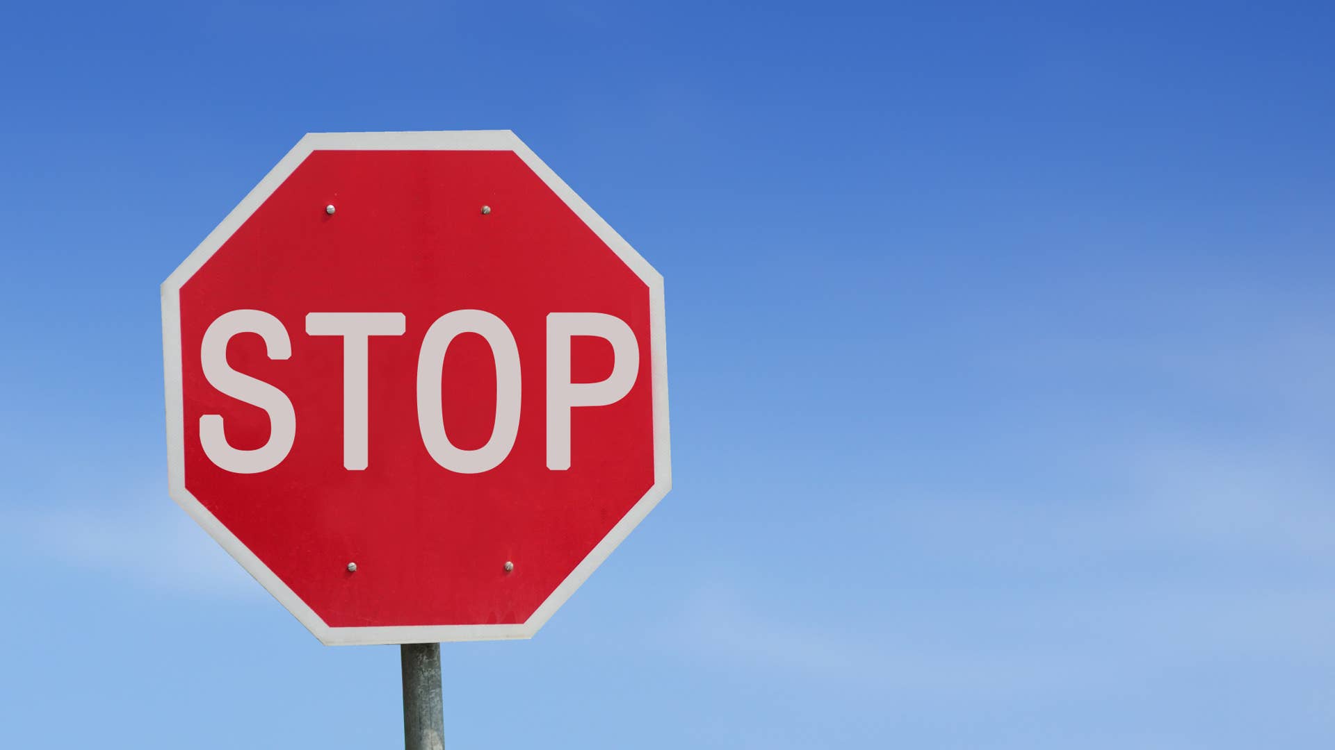 Stop sign blue sky background. Thailand Language.