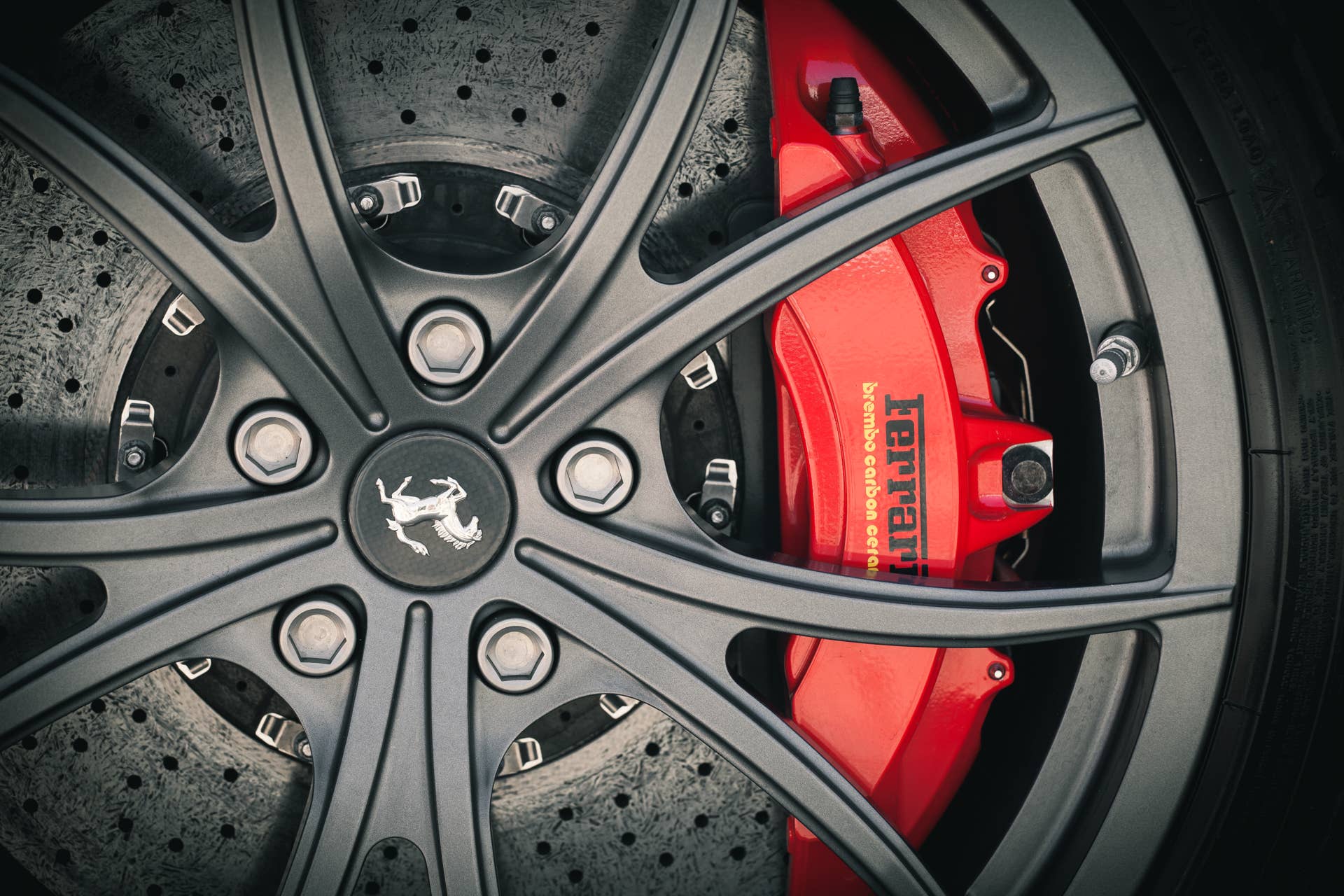 Sopot, Poland - 17 August 2013. Detail shot of a Ferrari 458 Italia supercar showing a fragment of its wheel and massive disc brakes. Photo taken near Sopot pier venue (the Molo). Shot during a Ferrari dealer presentation which was part of the program at Sopot Match Race 2013.