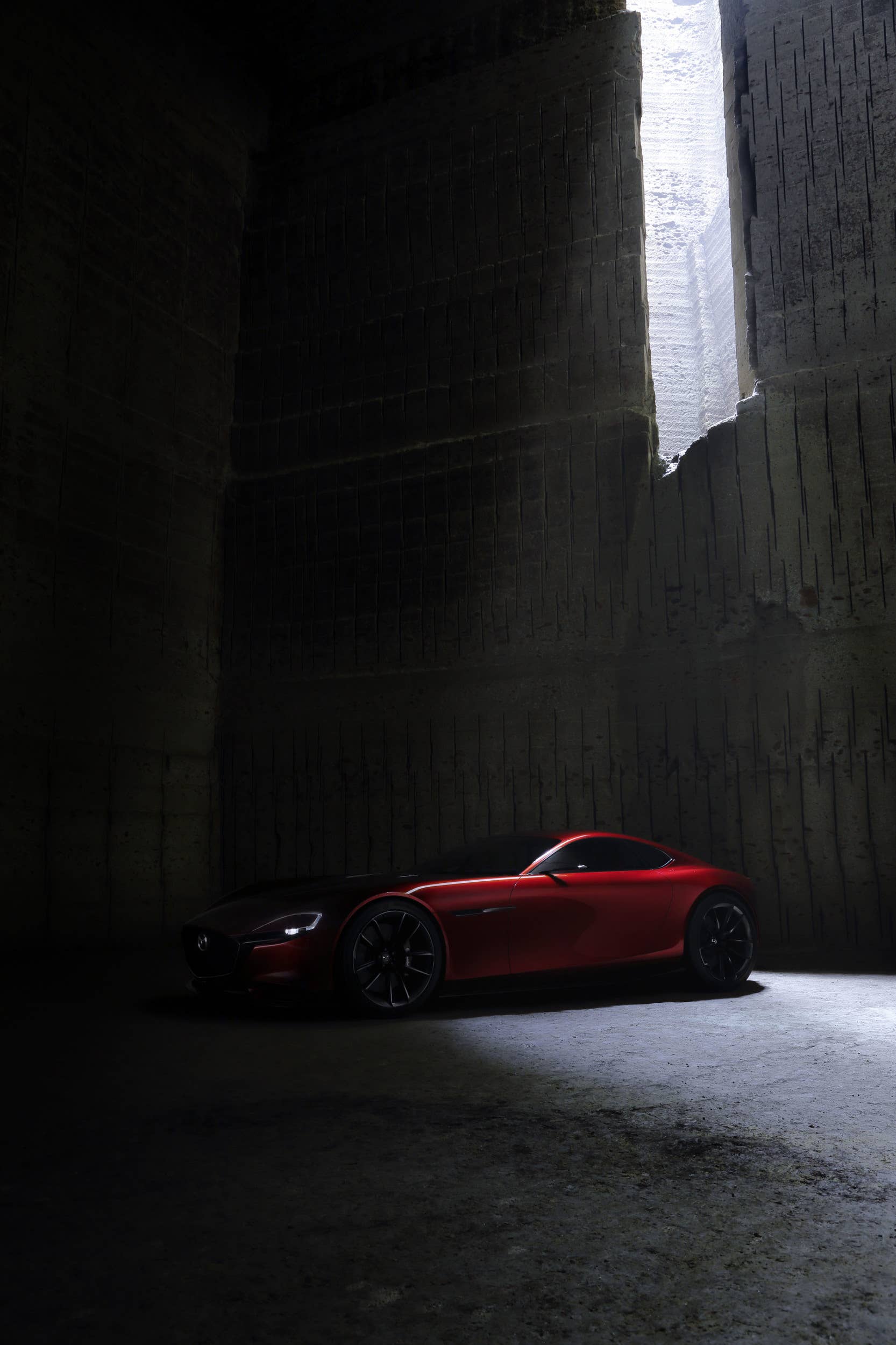 red mazda rx-vision concept in shadow
