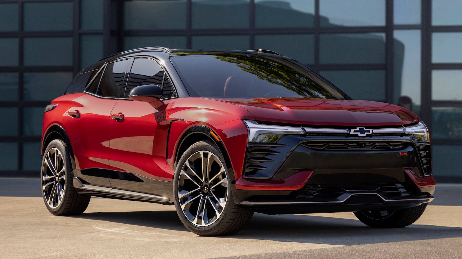 Three-quarter view of 2024 Chevrolet Blazer EV SS in Radiant Red Tintcoat. Preproduction model shown. Actual production model may vary. 2024 Chevrolet Blazer EV available Spring 2023.
