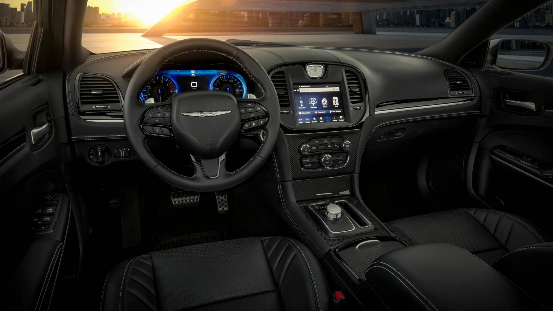 The interior of the 2023 Chrysler 300C features silver stitching that reaches the doors, console, seats and leather instrument panel, with carbon fiber and Piano Black touches on the interior bezels.