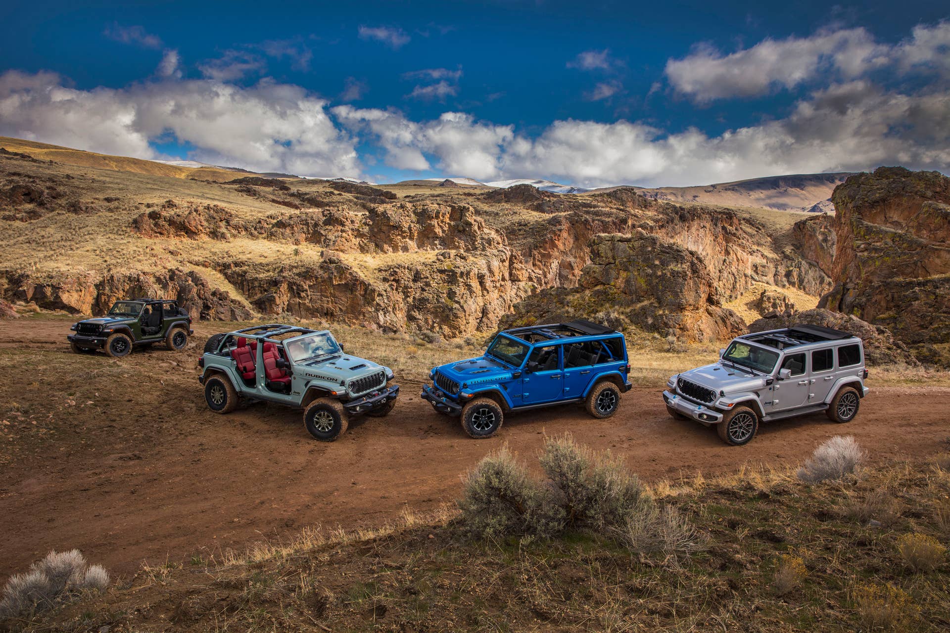 (Left to right) New 2024 Jeep® Wrangler Willys, Wrangler Rubicon 392, Wrangler Rubicon X 4xe and Wrangler High Altitude 4xe