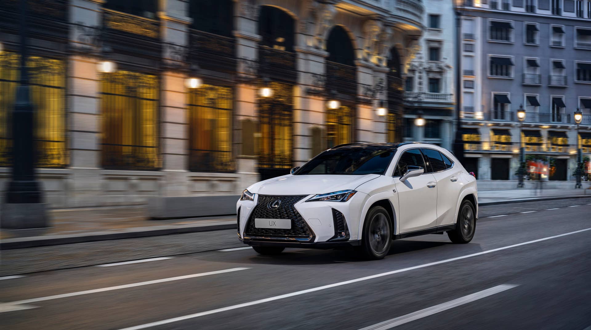2025 Lexus UX 300h white front angled view driving