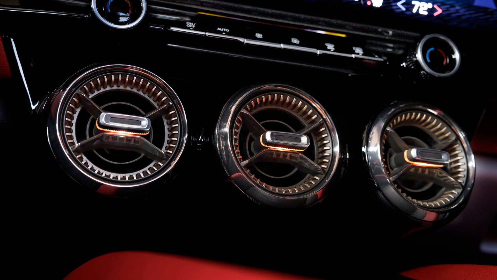 Close up of round air vents in tech bronze inside the 2024 Chevrolet Blazer EV SS in Radiant Red Tintcoat with Adrenaline Red interior. Preproduction model shown. Actual production model may vary. 2024 Chevrolet Blazer EV available Spring 2023.