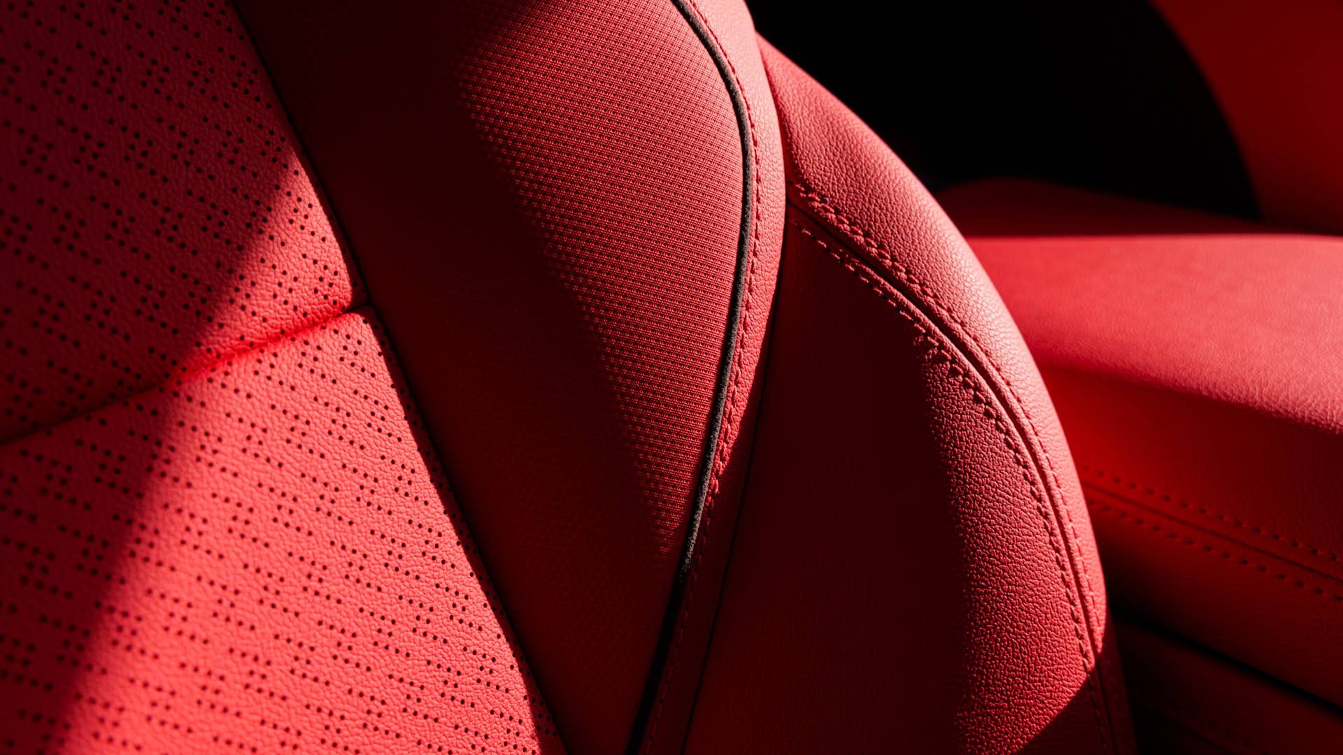 Close up of Adrenaline Red leather perforated seats in 2024 Chevrolet Blazer EV SS. Preproduction model shown. Actual production model may vary. 2024 Chevrolet Blazer EV available Spring 2023.