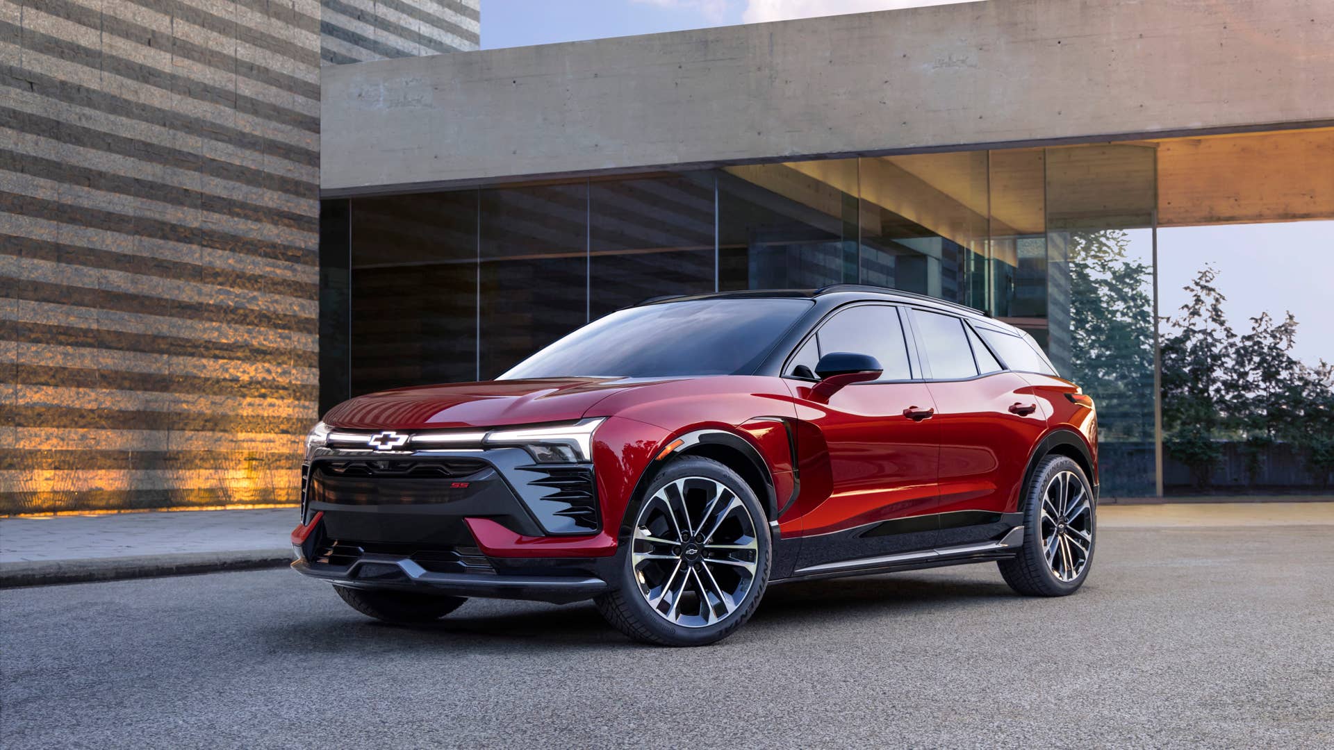 Seven-eighths view of 2024 Chevrolet Blazer EV RS in Radiant Red Tintcoat. Preproduction model shown. Actual production model may vary. 2024 Chevrolet Blazer EV available Spring 2023.