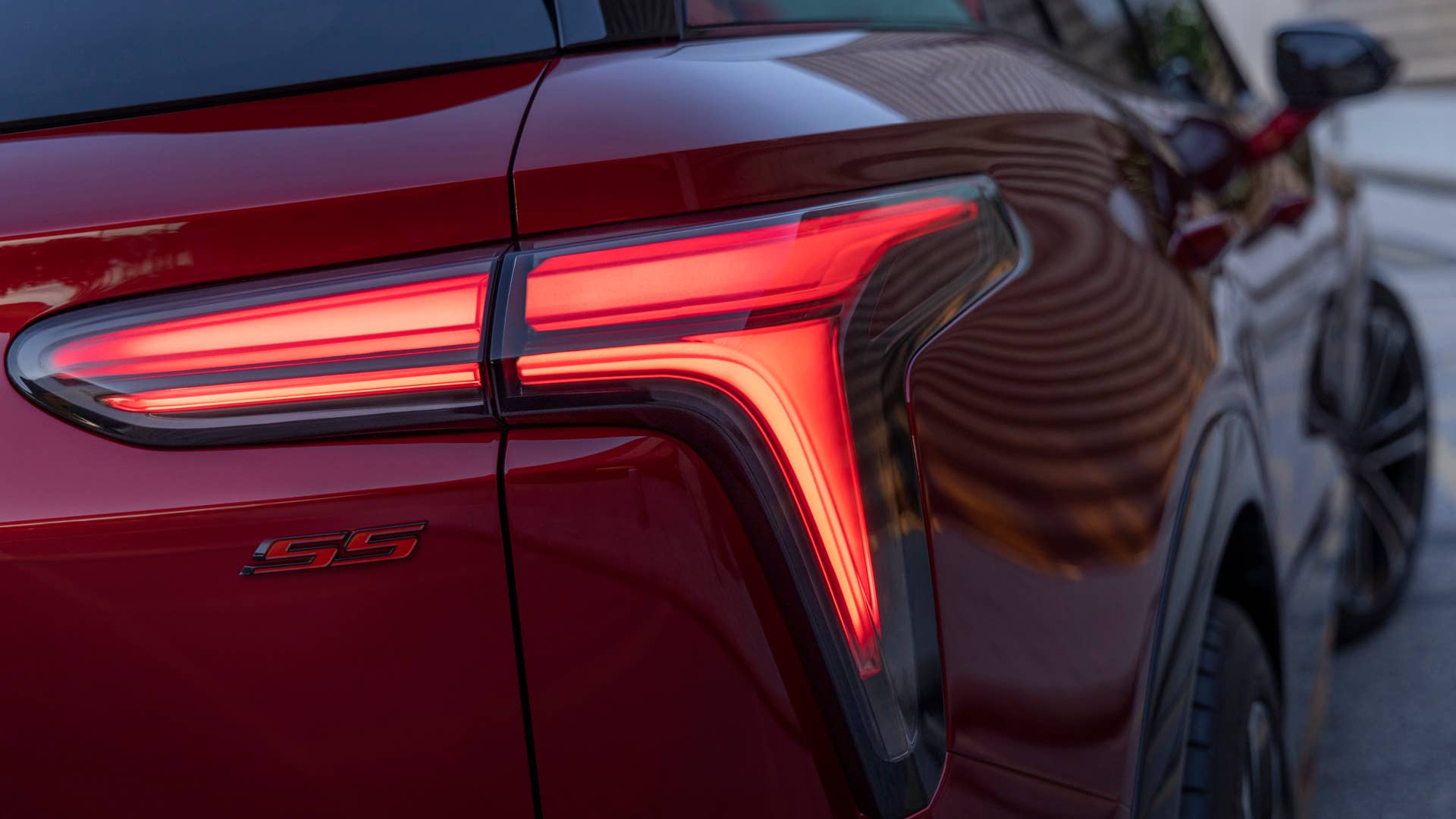 Close up of passenger’s side taillight and SS badge on 2024 Chevrolet Blazer EV SS in Radiant Red Tintcoat. Preproduction model shown. Actual production model may vary. 2024 Chevrolet Blazer EV available Spring 2023.