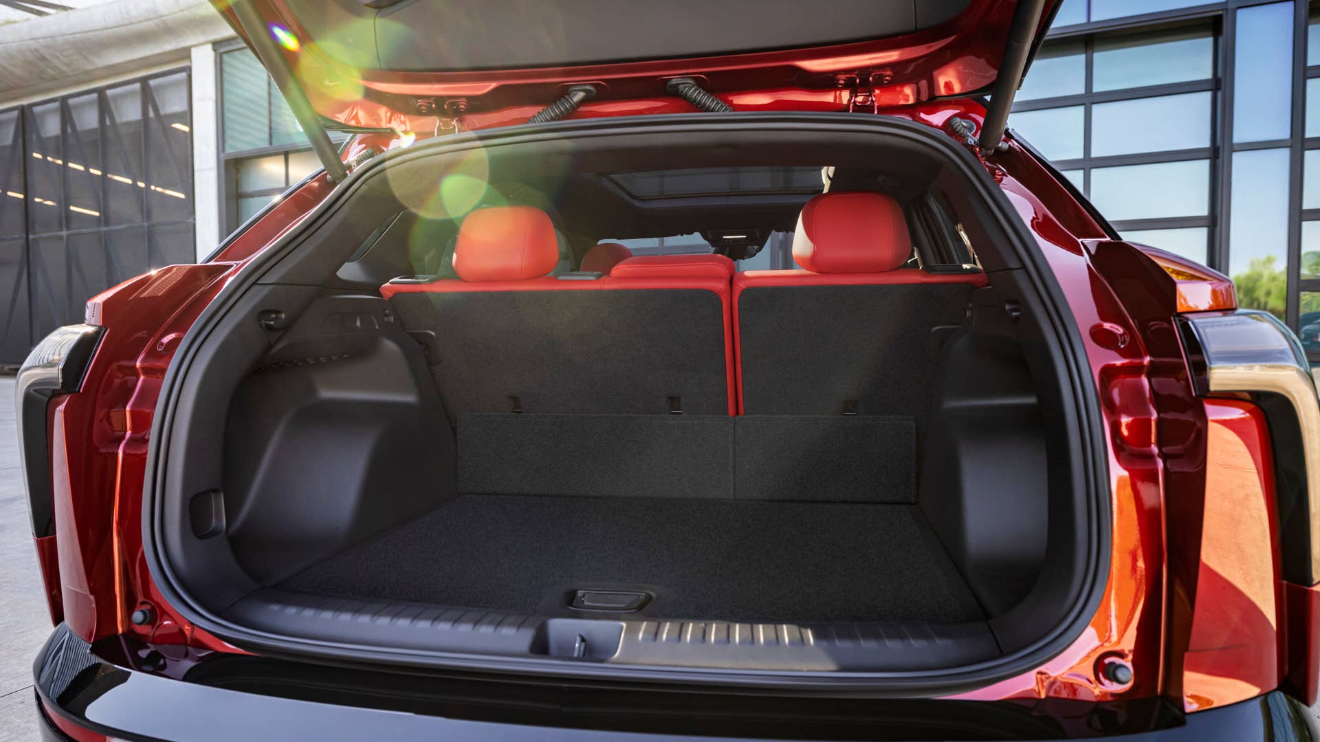 Rear view of 2024 Chevrolet Blazer EV SS in Radiant Red Tintcoat through open trunk. Preproduction model shown. Actual production model may vary. 2024 Chevrolet Blazer EV available Spring 2023.