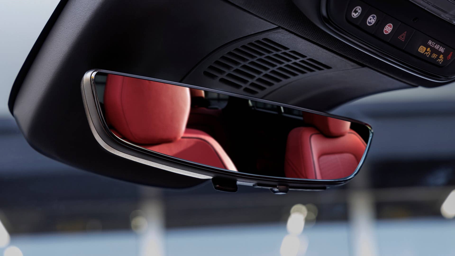 View of Adrenaline Red seats in rearview mirror of 2024 Chevrolet Blazer EV SS. Preproduction model shown. Actual production model may vary. 2024 Chevrolet Blazer EV available Spring 2023.