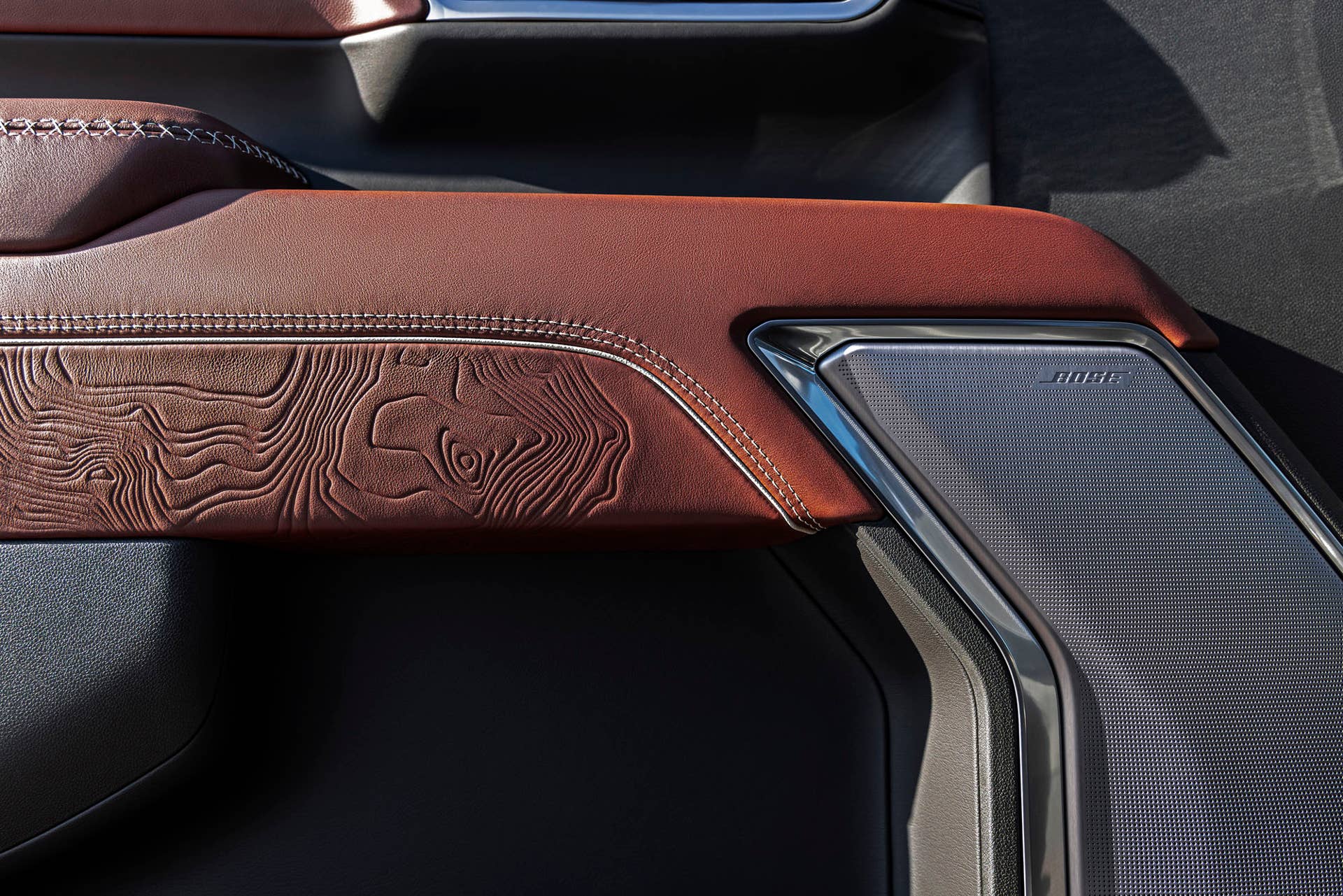 Darkened, open-pore Paldao wood etched with topography and coordinates of Mount Denali on the GMC Sierra 2500 HD Denali Ultimate