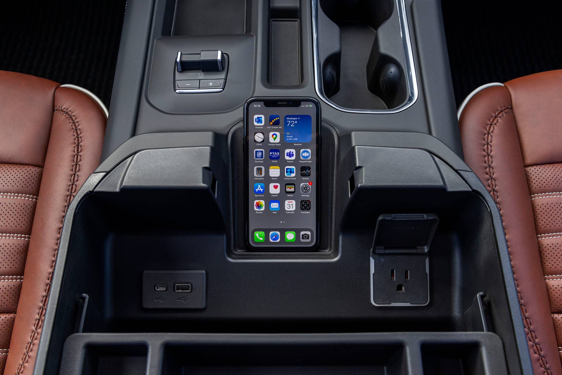 Interior close-up shot of the GMC Sierra 2500 HD Denali Ultimate center console and wireless phone charger