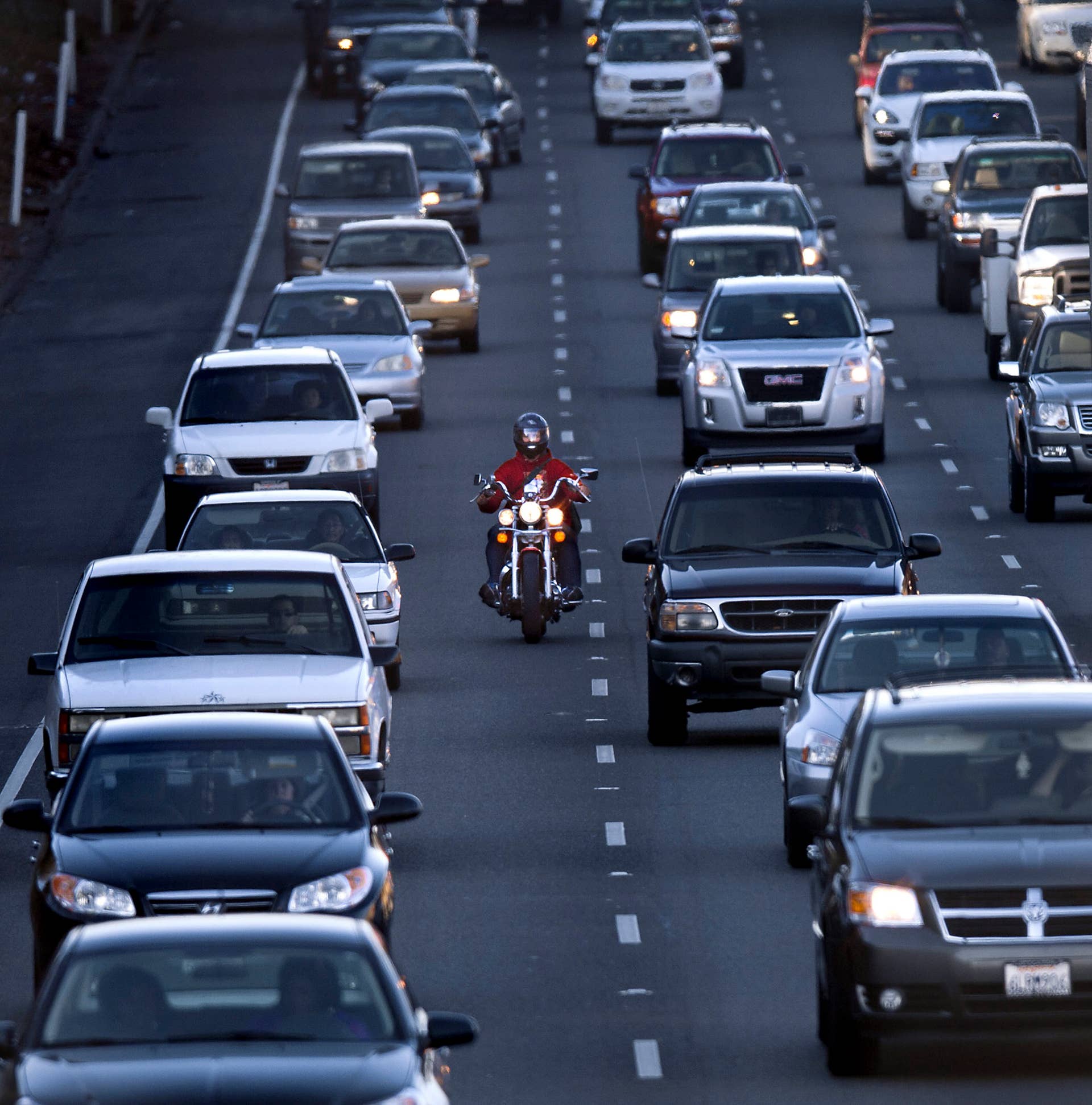 A motorcyclist rides between the lanes during the afternoon commute on southbound highway 99 in Sacramento, California, Tuesday, February 5, 2013. In an effort to make motorcycling safer, state officials have published guidelines in the common, but sometimes dangerous, practice of lane-splitting. (Randall Benton/Sacramento Bee/Tribune News Service via Getty Images)