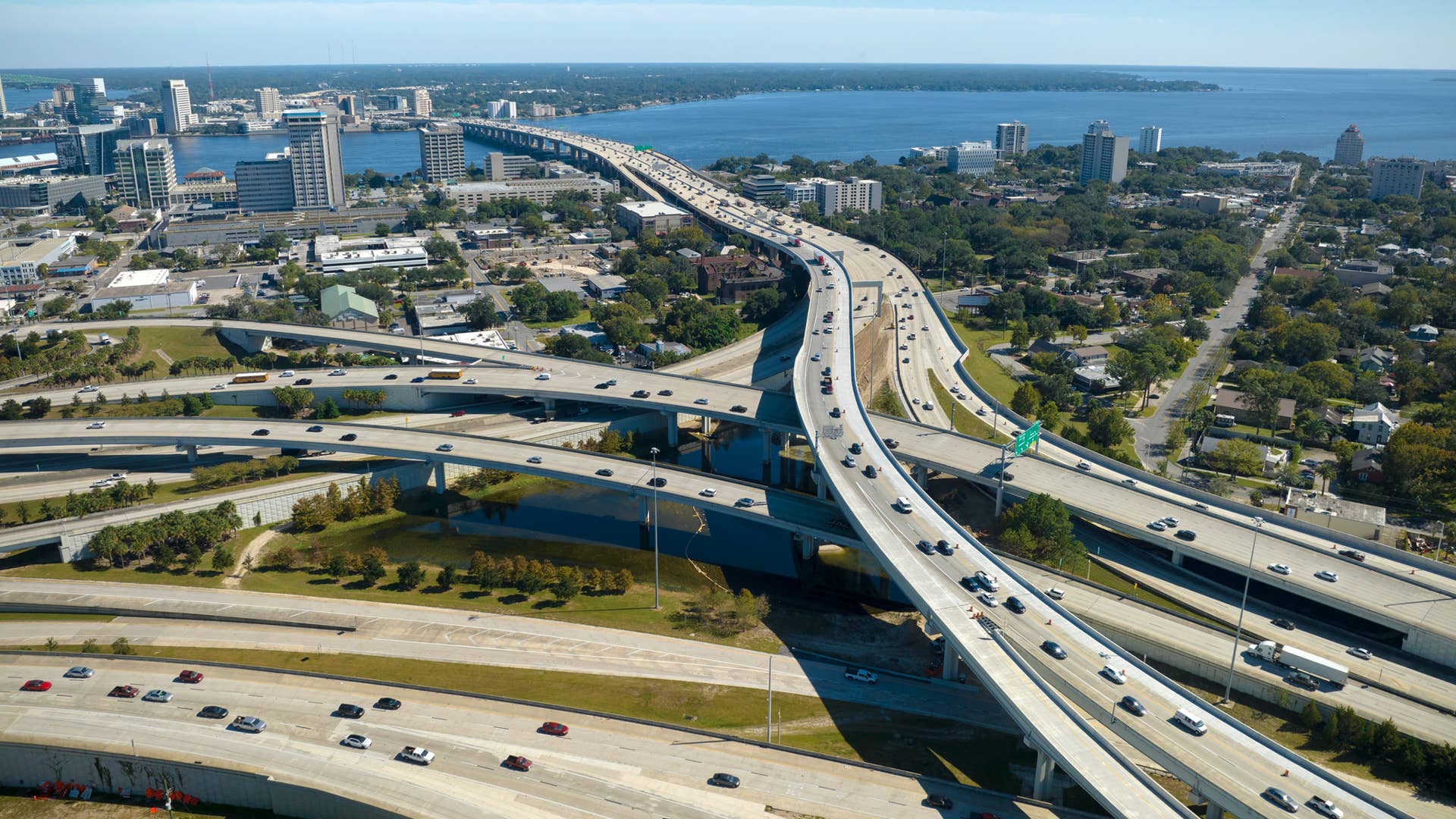 Aerial view of american freeway intersection with fast moving cars and trucks. USA transportation infrastructure concept
