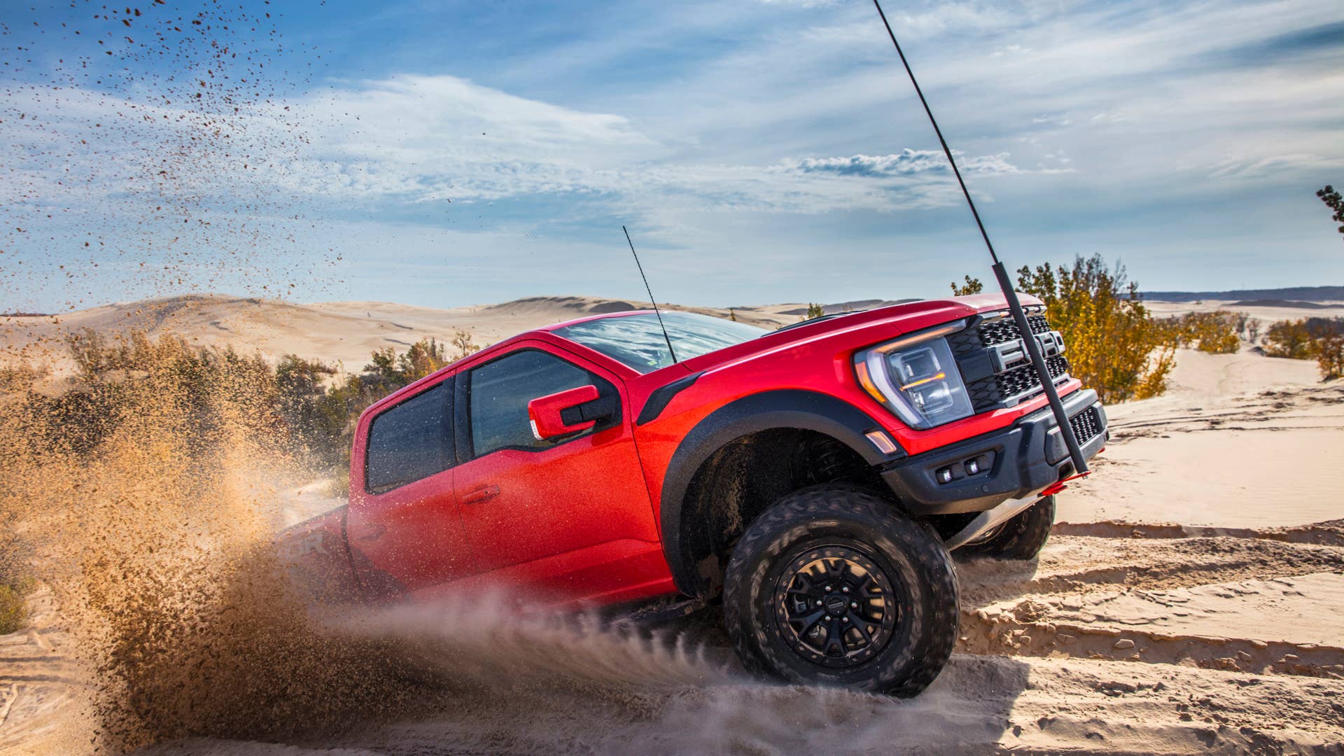 Preproduction 2023 F-150 Raptor R with aftermarket flag and optional equipment. Available late 2022. Professional driver on a closed course. Always consult the Raptor supplement to the Owner’s Manual before off-road driving, know your terrain and trail difficulty, and use appropriate safety gear.