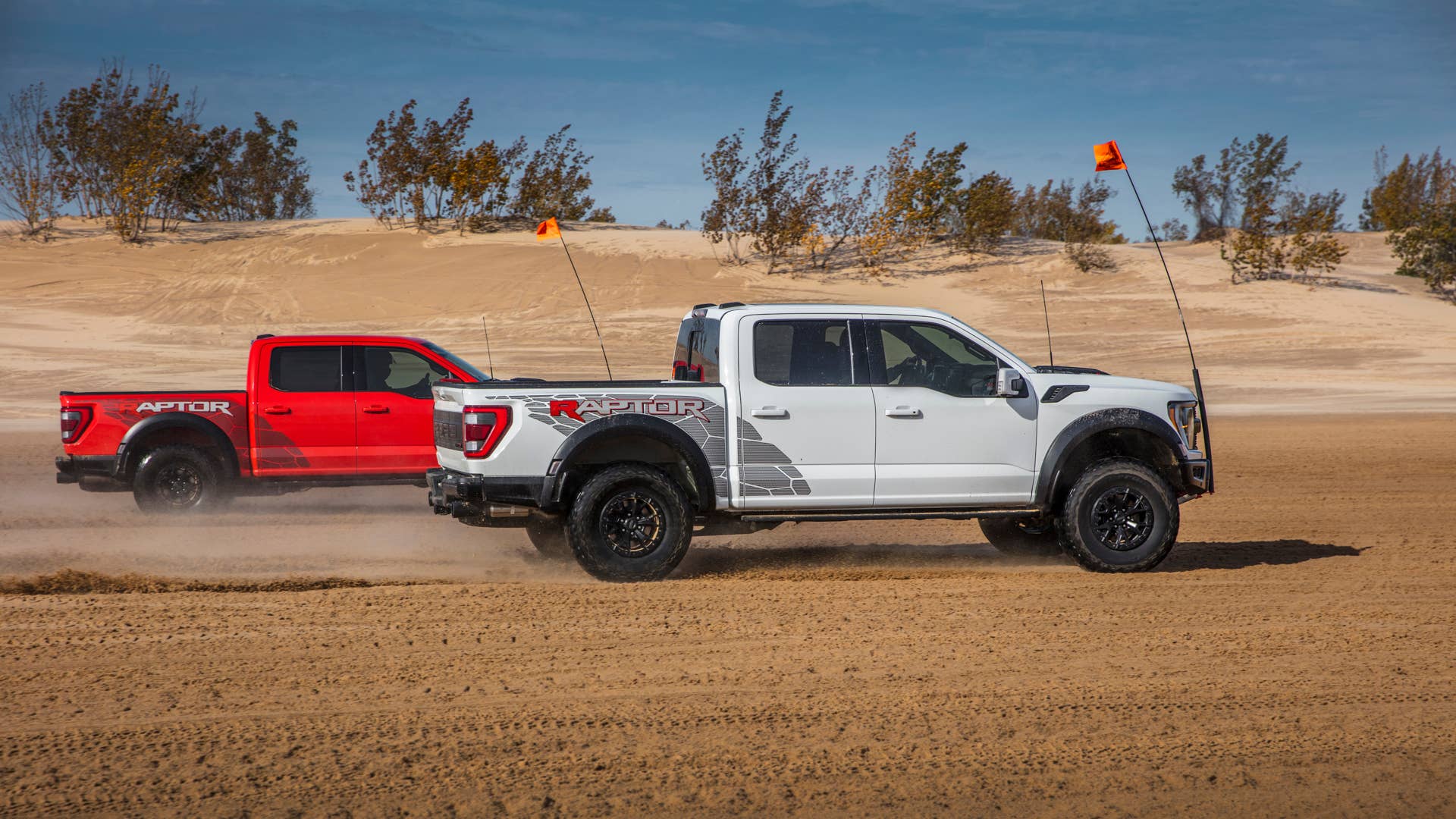 Preproduction 2023 F-150 Raptor R with aftermarket flag and optional equipment. Available late 2022. Professional driver on a closed course. Always consult the Raptor supplement to the Owner’s Manual before off-road driving, know your terrain and trail difficulty, and use appropriate safety gear.