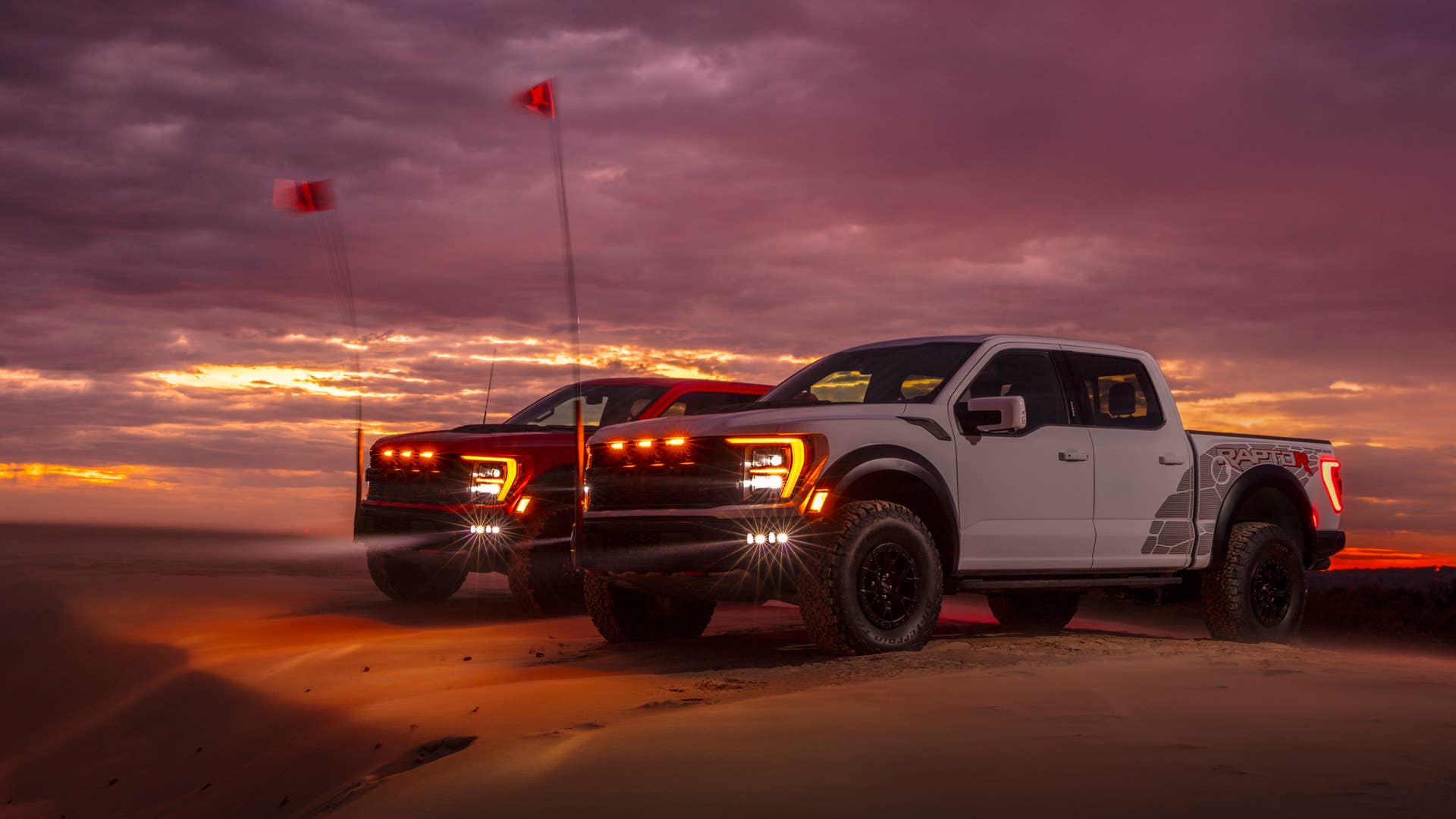 Preproduction 2023 F-150 Raptor R with aftermarket flag and optional equipment. Available late 2022. Professional driver on a closed course. Always consult the Raptor supplement to the Owner’s Manual before off-road driving, know your terrain and trail difficulty, and use appropriate safety gear.