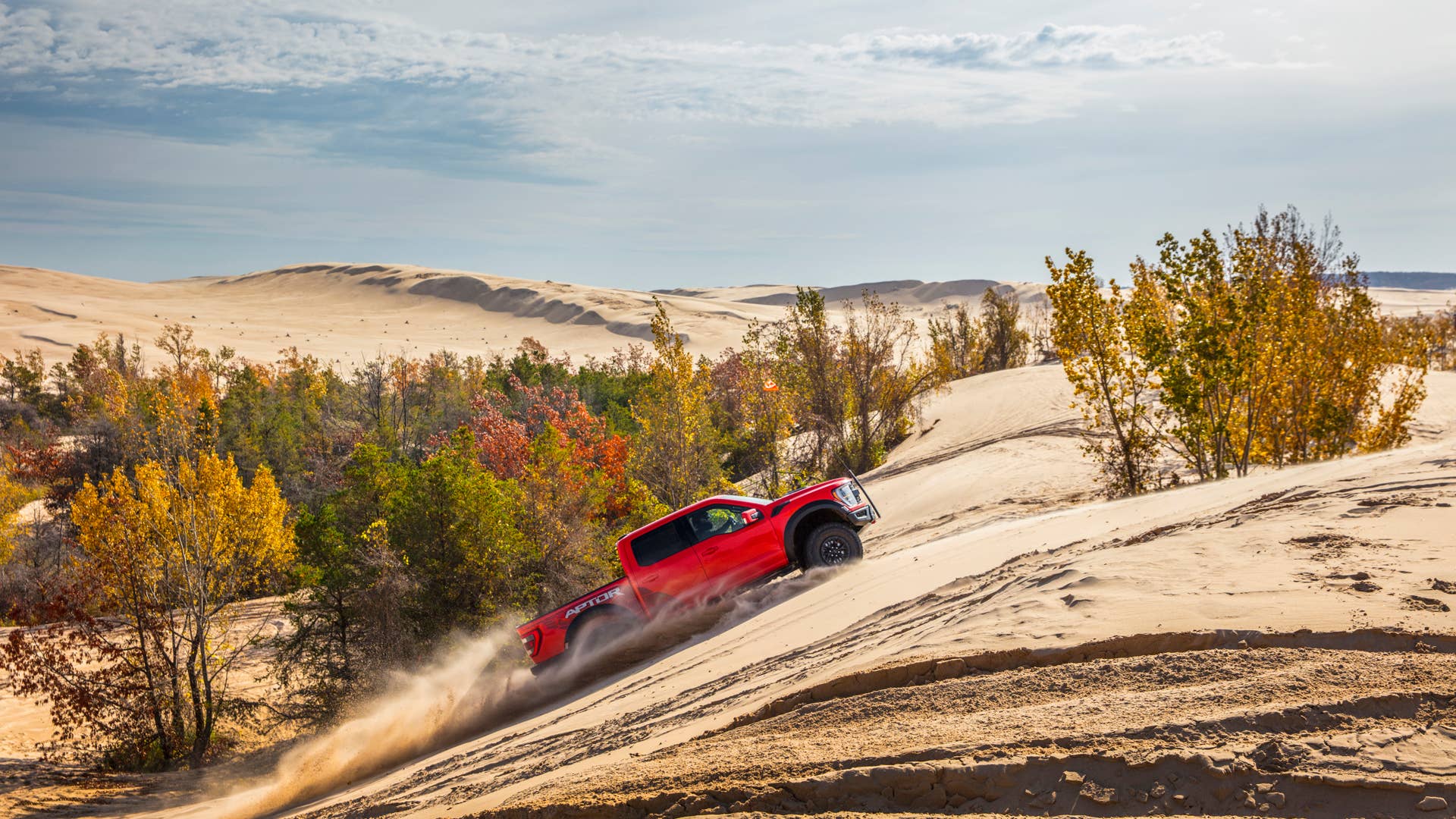 Preproduction 2023 F-150 Raptor R with aftermarket flag and optional equipment. Available late 2022. Professional driver on a closed course. Always consult the Raptor supplement to the Owner’s Manual before off-road driving, know your terrain and trail difficulty, and use appropriate safety gear.