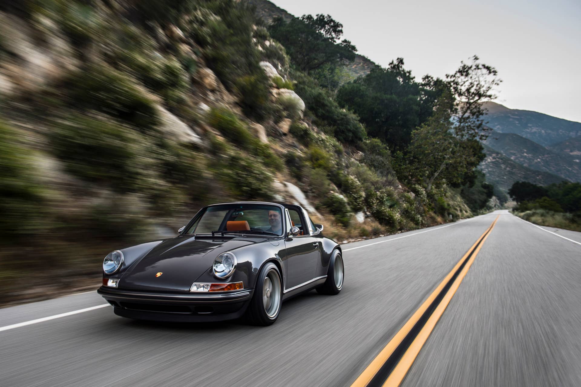 porsche 911 targa 4.0 restored by singer front driving mountain road