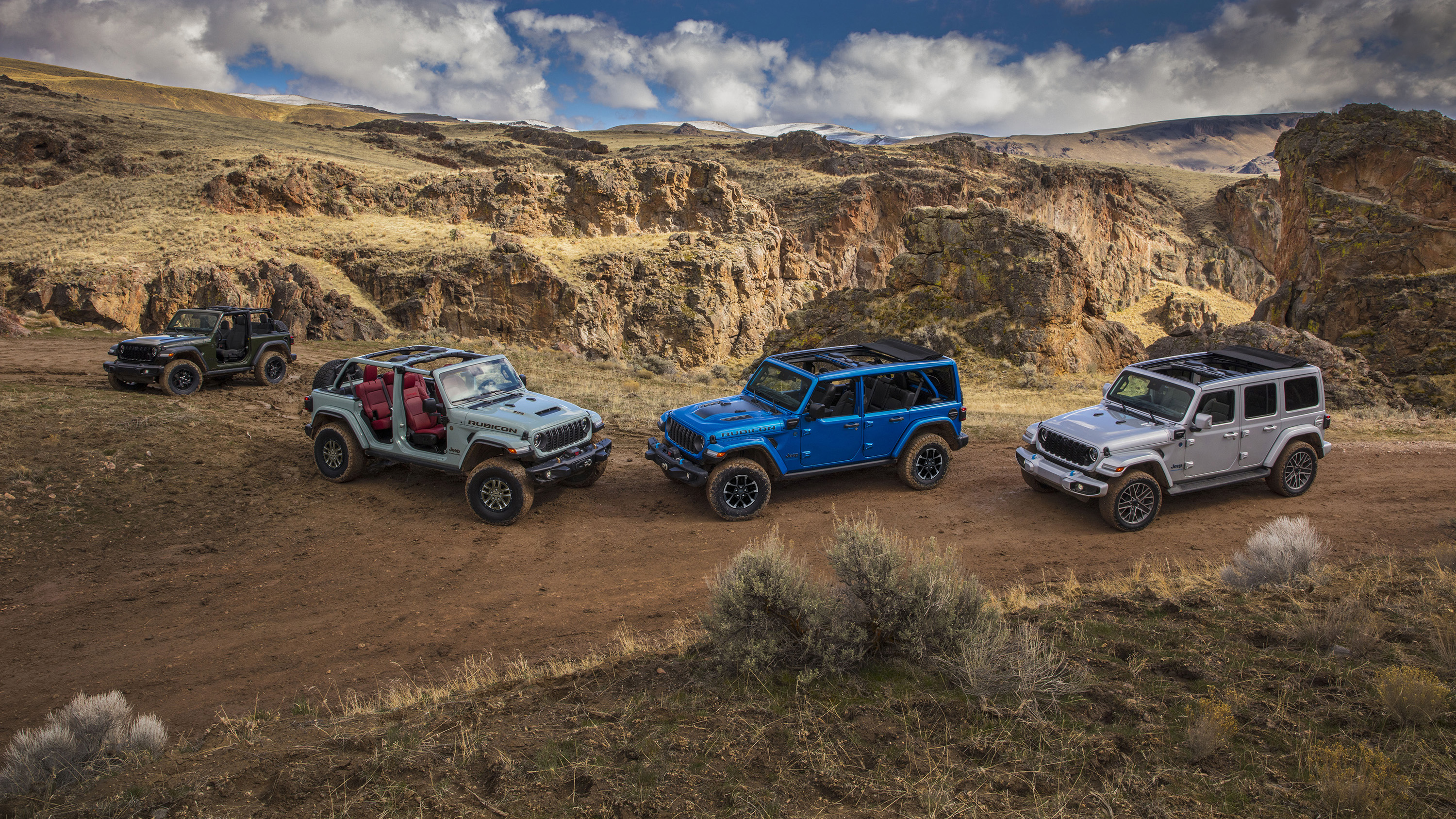 (Left to right) New 2024 Jeep® Wrangler Willys, Wrangler Rubicon 392, Wrangler Rubicon X 4xe and Wrangler High Altitude 4xe