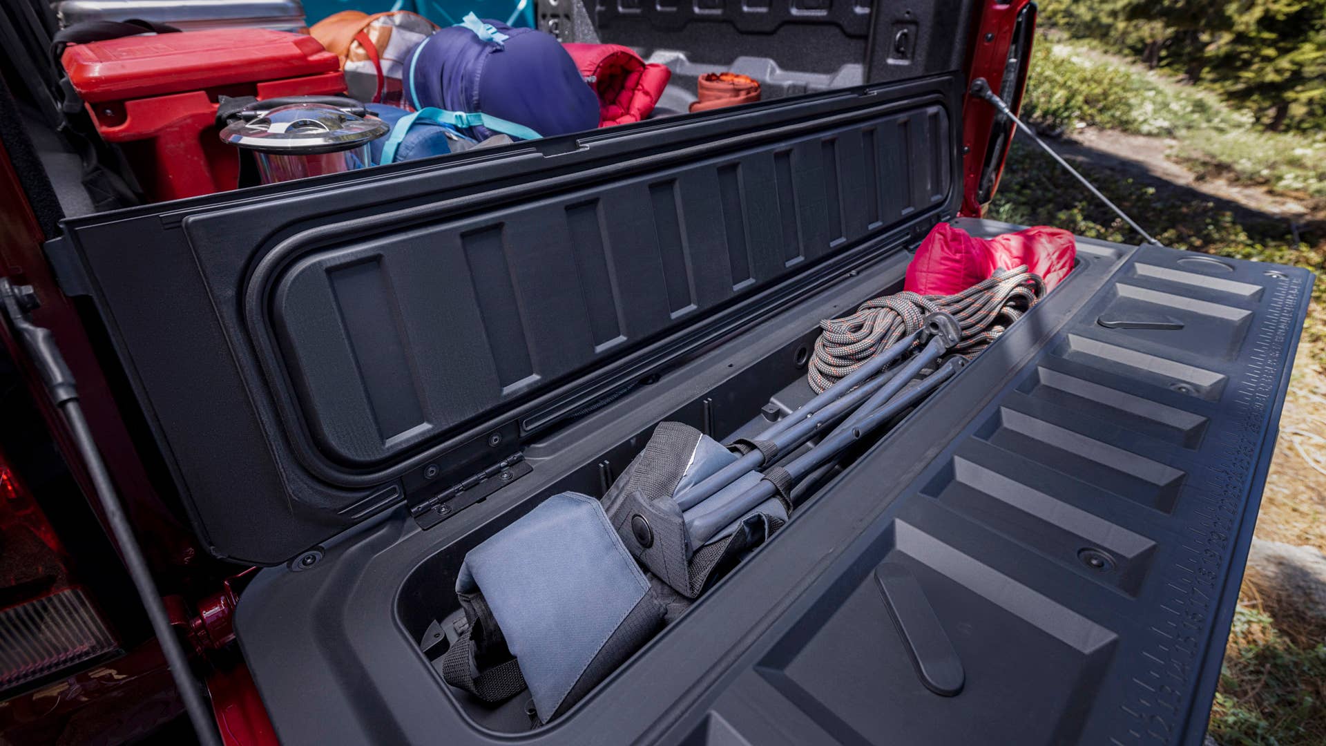 Lifestyle shot demonstrating how to optimize space in the truck bed's unique storage compartements with props.