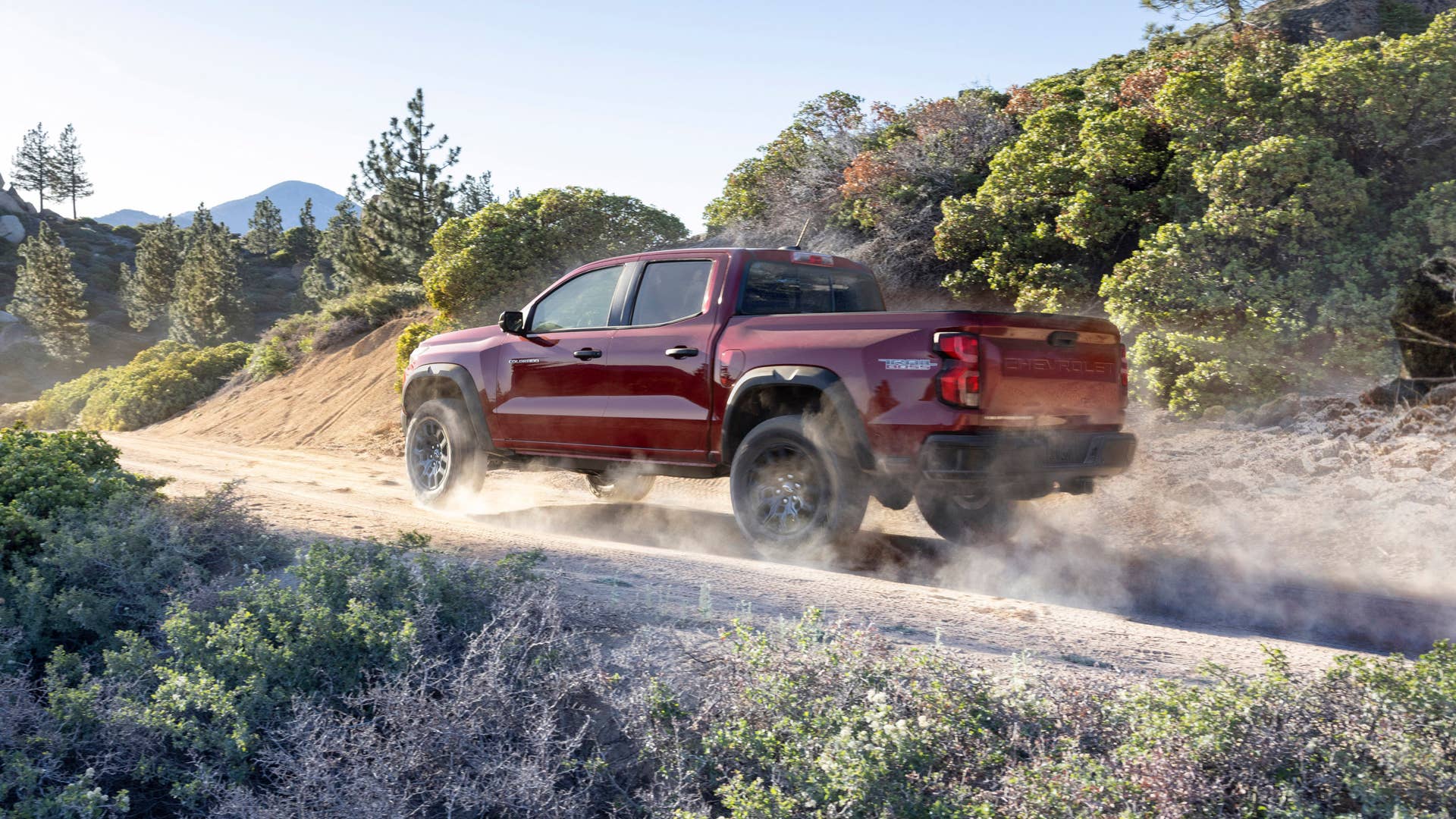 Rear 3/4 view of Colorado Trail Boss kicking up dirt behind the truck.