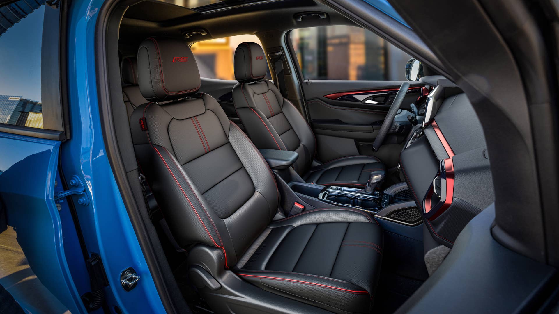 View of front cabin from passenger’s side in 2024 Chevrolet Trailblazer RS in Fountain Blue with Jet Black with Red Accents interior. Preproduction model shown. Actual production model may vary. Available in fall 2023.