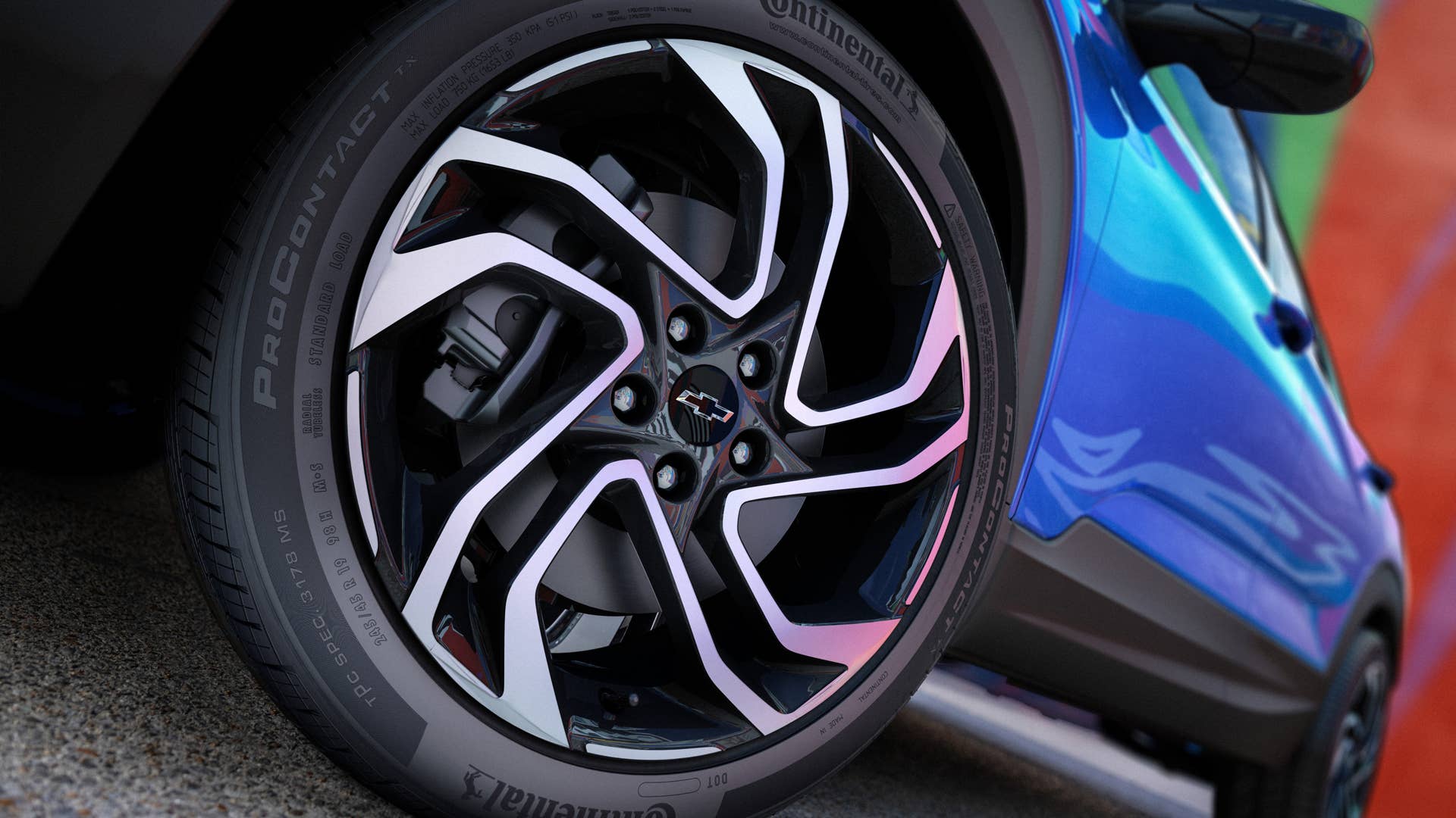 Close up view of driver’s side front wheel on 2024 Chevrolet Trailblazer RS in Fountain Blue parked in front of a building. Preproduction model shown. Actual production model may vary. Available in fall 2023.