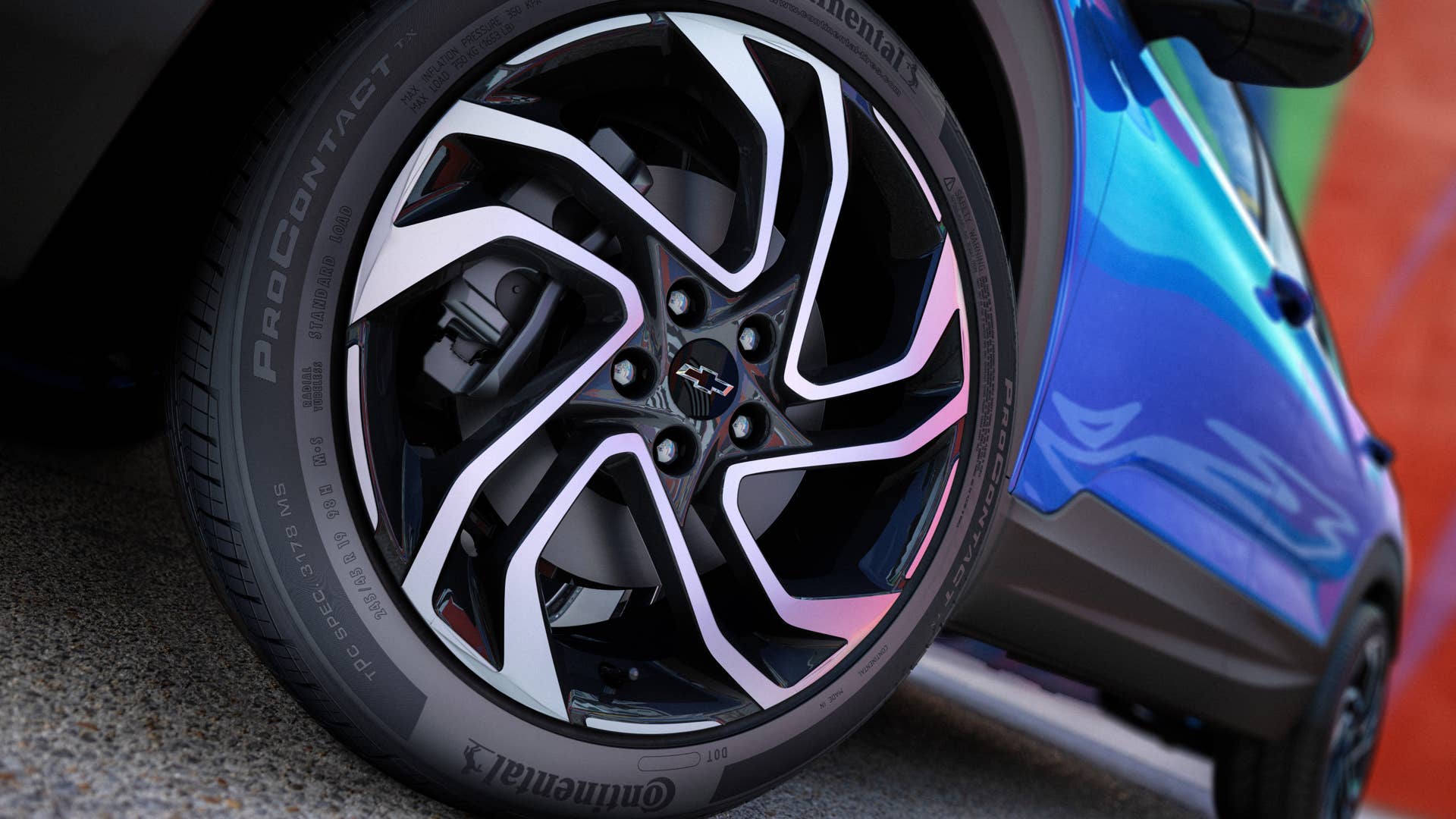 Close up view of driver’s side front wheel on 2024 Chevrolet Trailblazer RS in Fountain Blue parked in front of a building. Preproduction model shown. Actual production model may vary. Available in fall 2023.