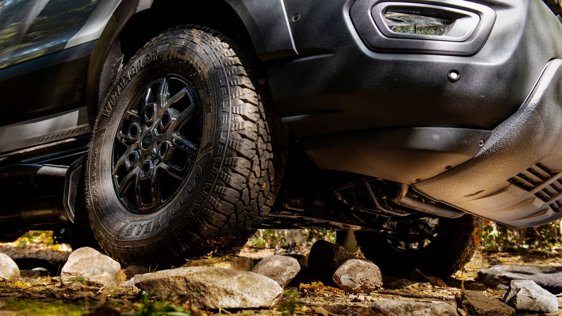 The 2023 Transit Trail van comes standard with 30.5-inch Goodyear Wrangler Workhorse all-terrain tires and 16-inch black alloy wheels. (2023 Ford Transit Trail available Fall 2022. Preproduction model shown. Always consulate Owner's Manual before off-road driving, know your terrain trail difficult, and use appropriate safety gear.)