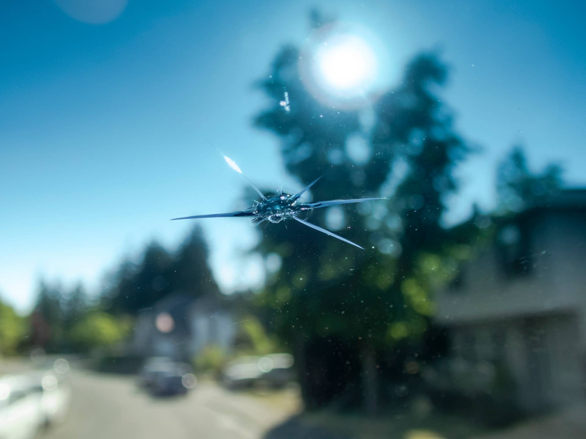 POV of a car windshield with a small rock chip as seen from the drivers seat. AccidentsnCreativeContentBriefn 775038209